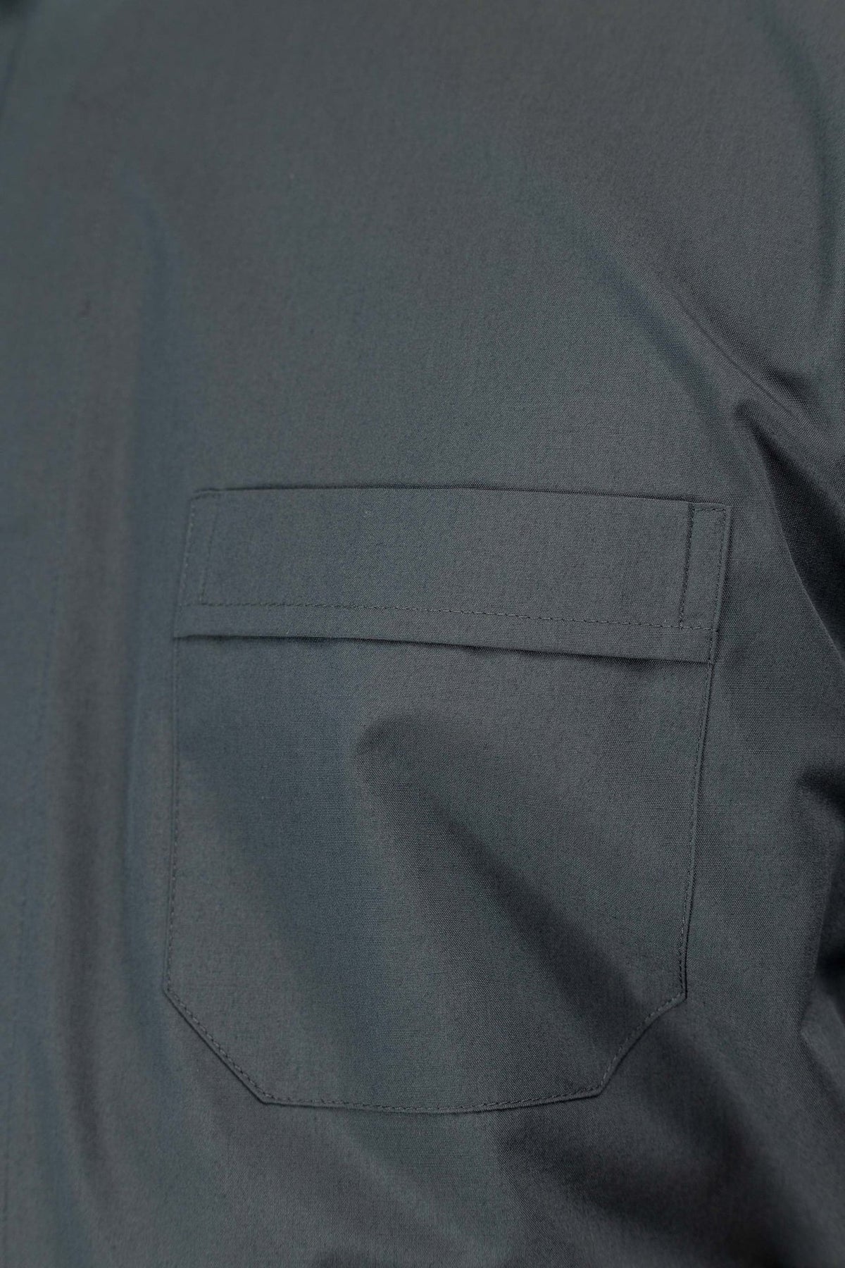 Dark gray clergy shirt close-up of chest pocket