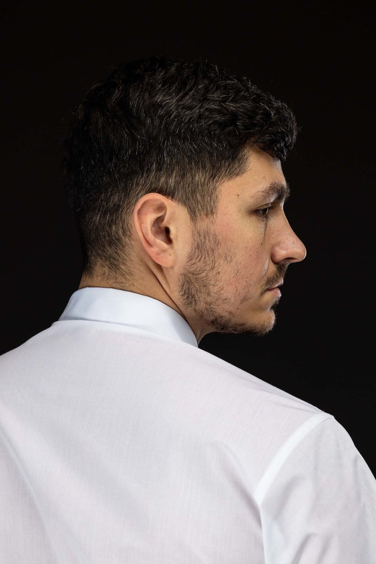 Clergy shirt side-back view showing the collar, shoulder seam and short sleeve