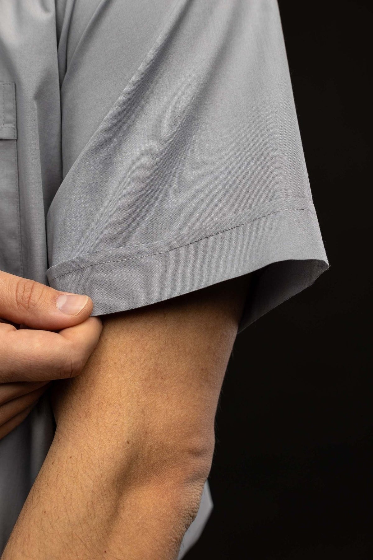 Light gray clergy shirt close-up of short sleeve with cuff