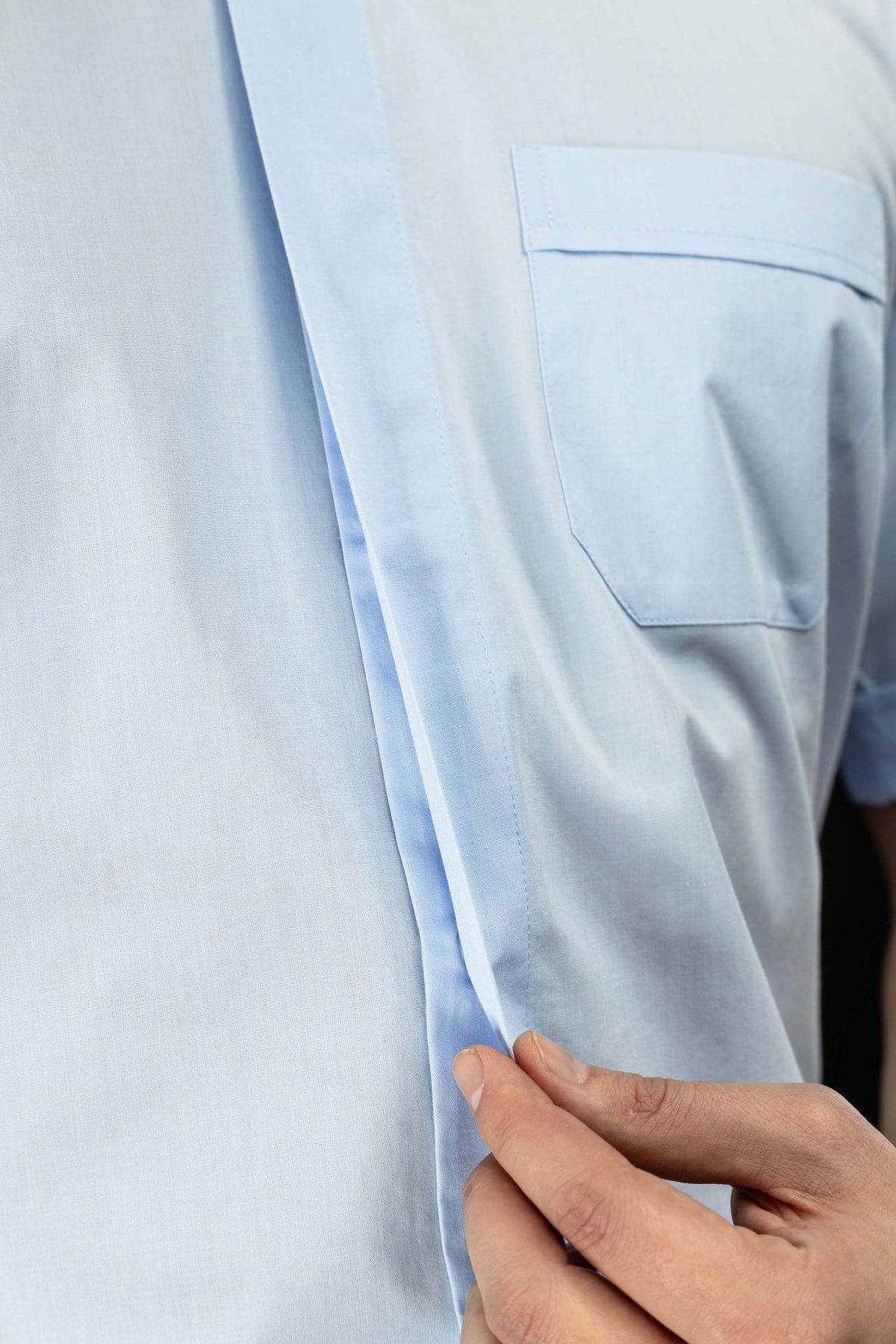 Light blue clergy shirt close-up of the front placket and chest pocket