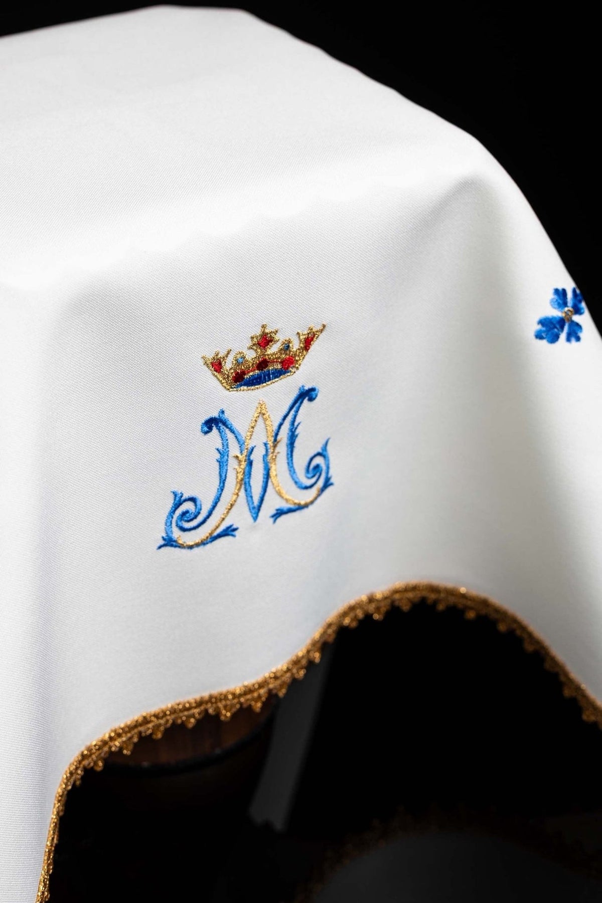 Chalice veil close-up of crowned Marian monogram embroidery and gold-trimmed edge
