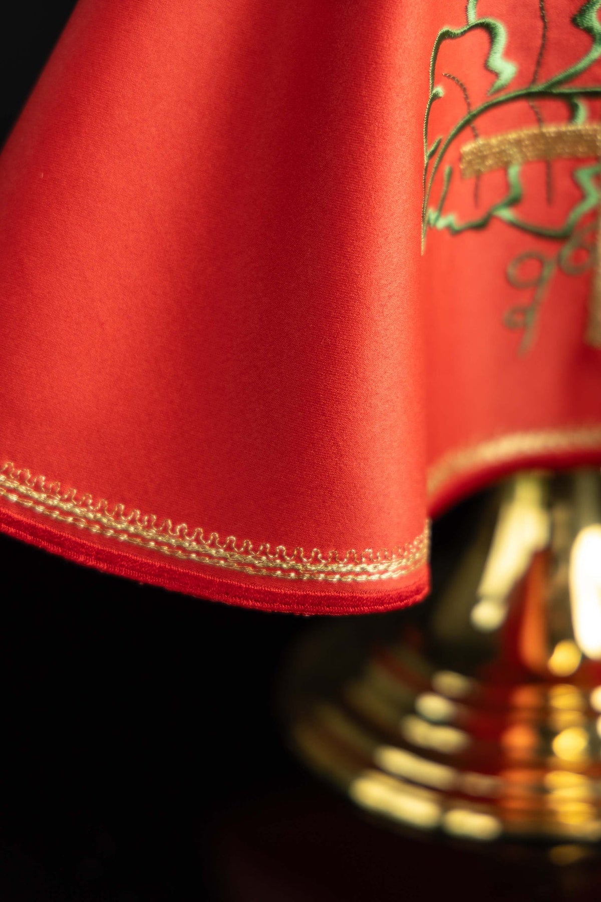 Ciborium veil close-up showing red fabric and gold embroidered hem