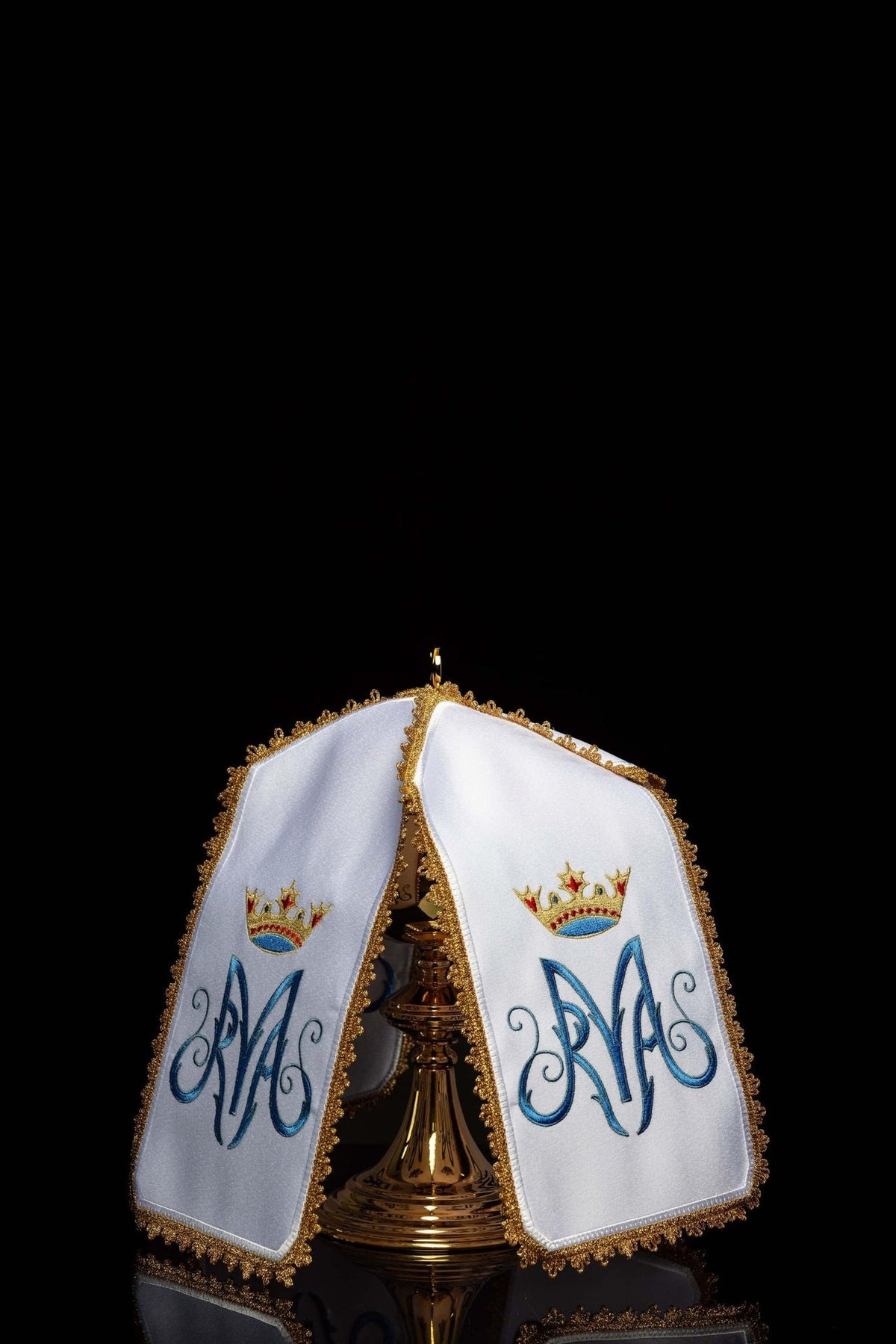 Ciborium veil shown open around a ciborium, with matching Marian motif embroidery