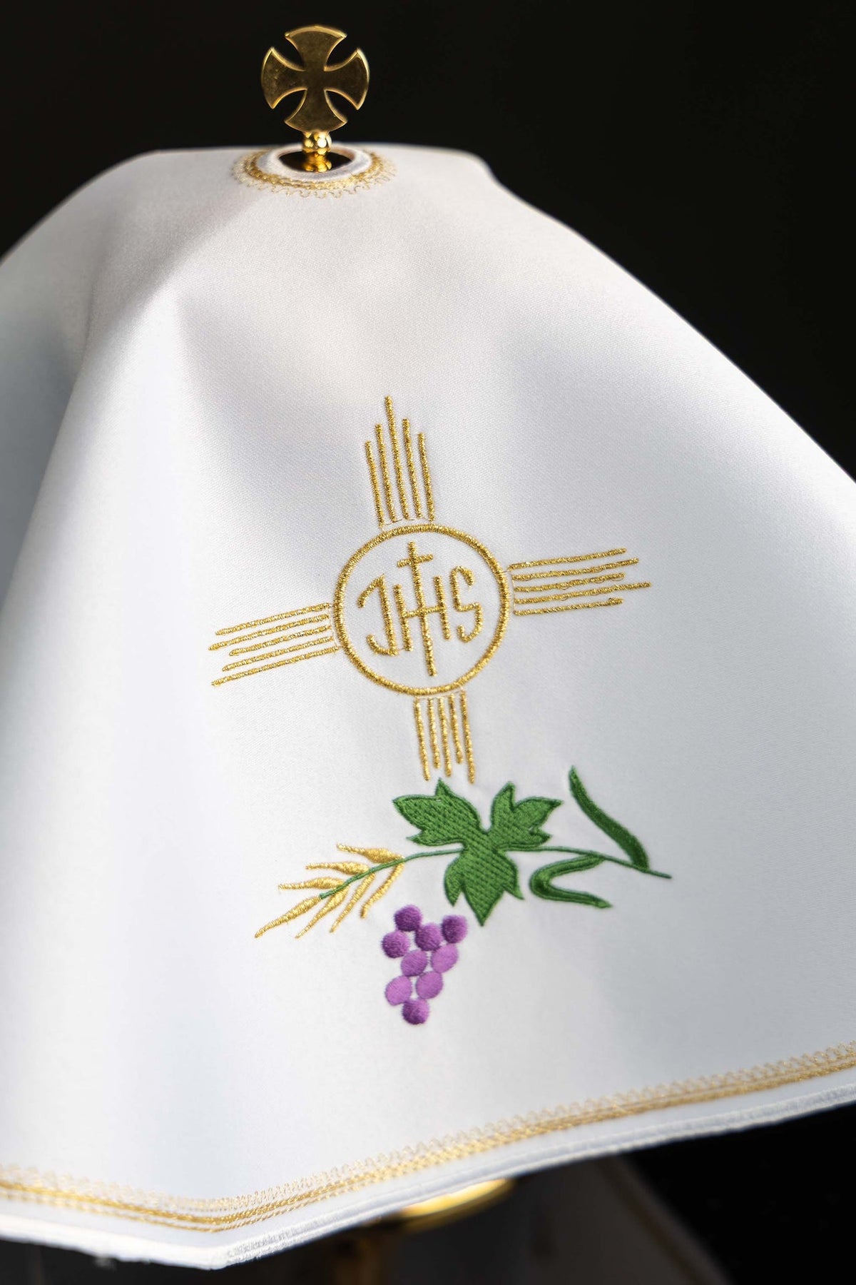 Ciborium veil close-up showing gold IHS and grapevine embroidery