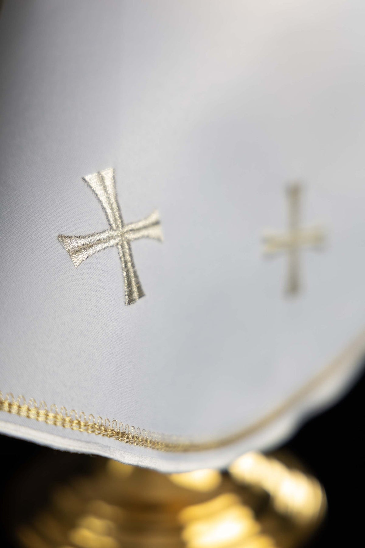 Ciborium veil detail showing gold embroidered edging and white fabric