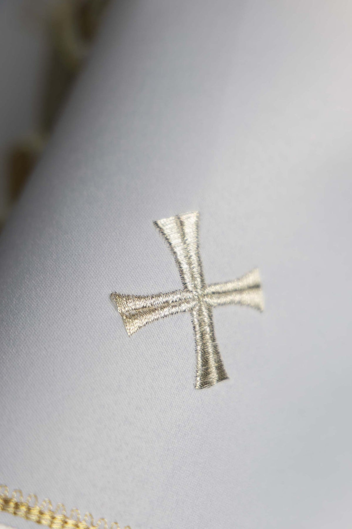 Ciborium veil detail showing a silver embroidered cross and gold edging
