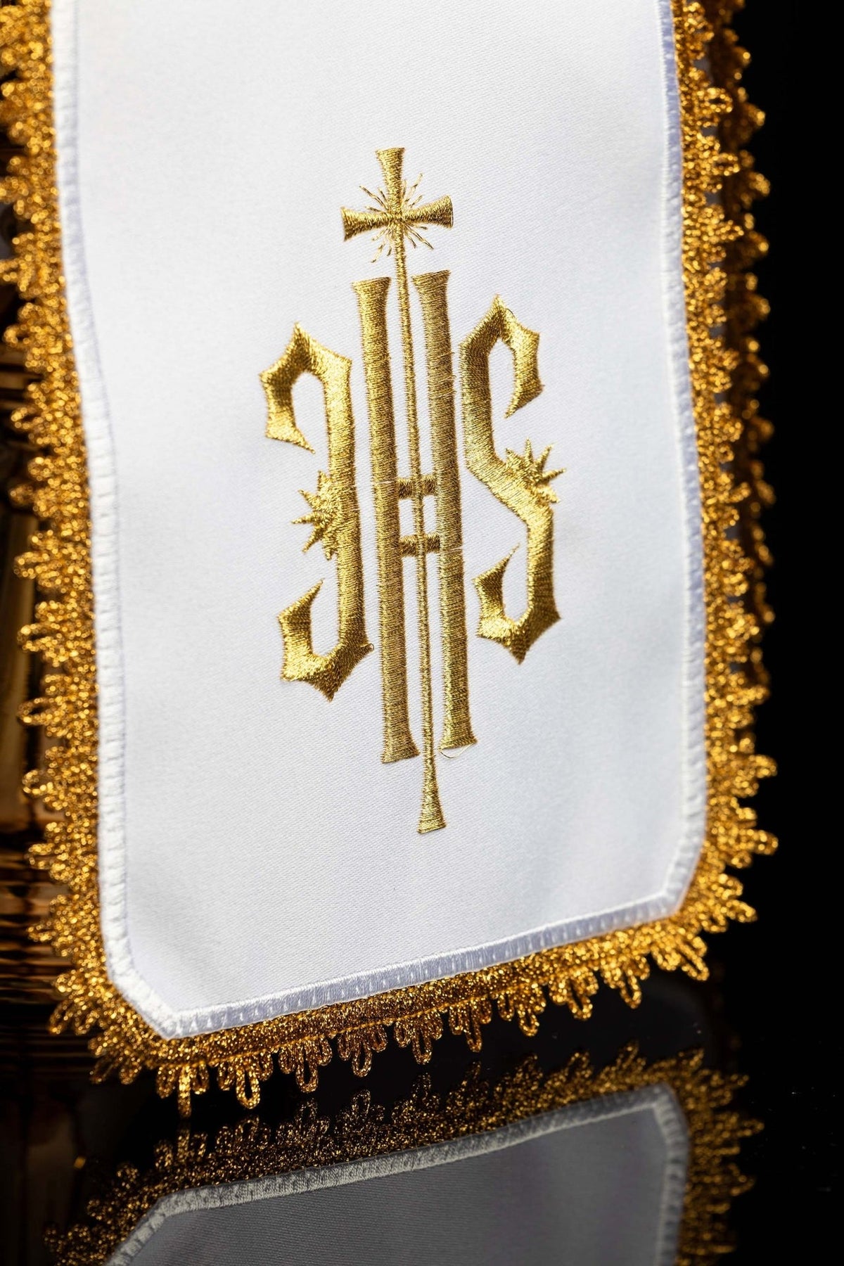 Ciborium veil close-up showing gold IHS monogram embroidery and ornate gold edging