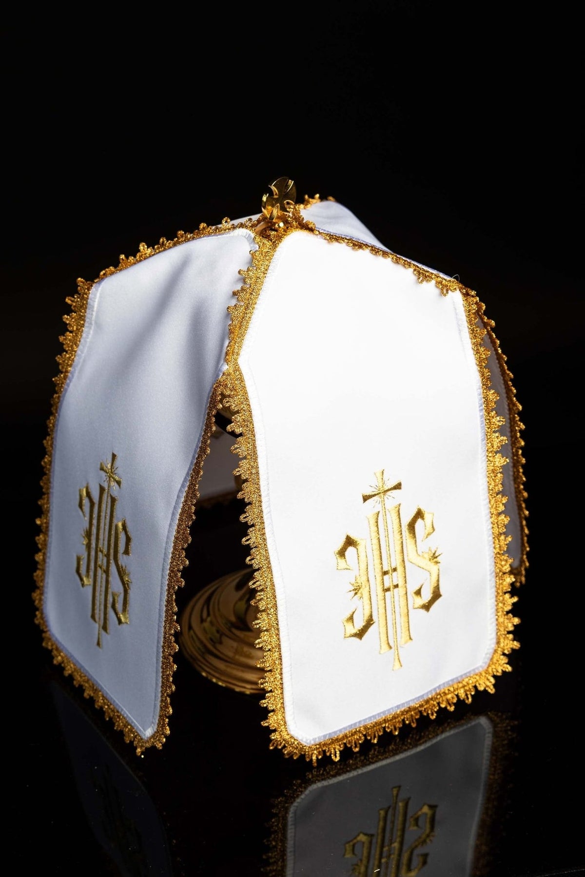 Ciborium veil three-quarter view showing white panels, gold IHS monogram embroidery and trim