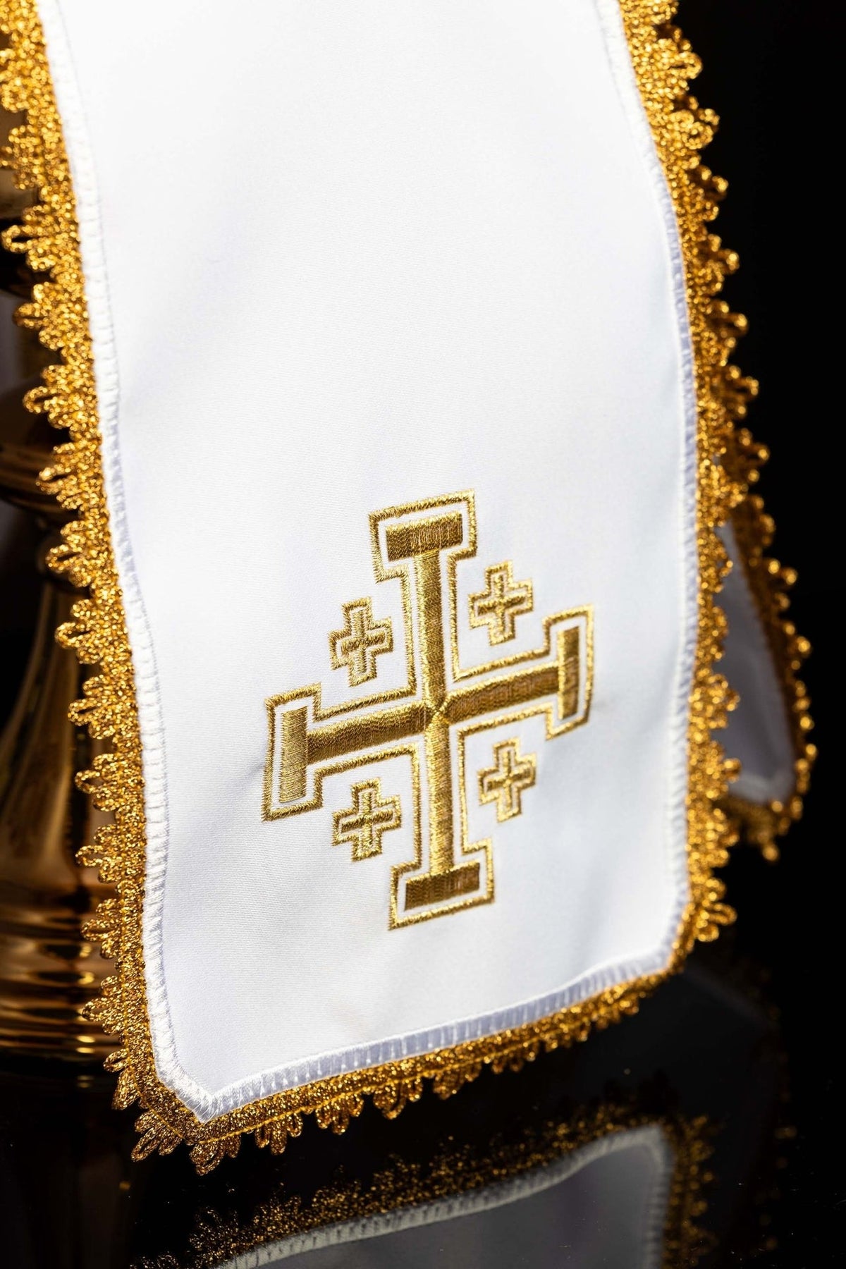 Ciborium veil close-up showing gold Jerusalem cross embroidery and ornate trim