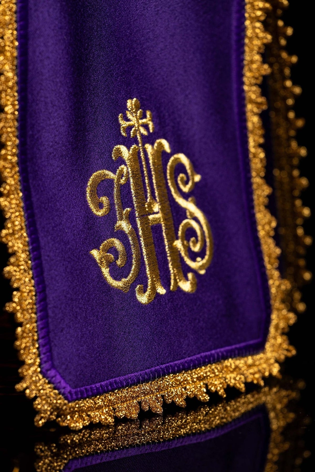 Purple ciborium veil close-up showing gold IHS monogram embroidery and trim