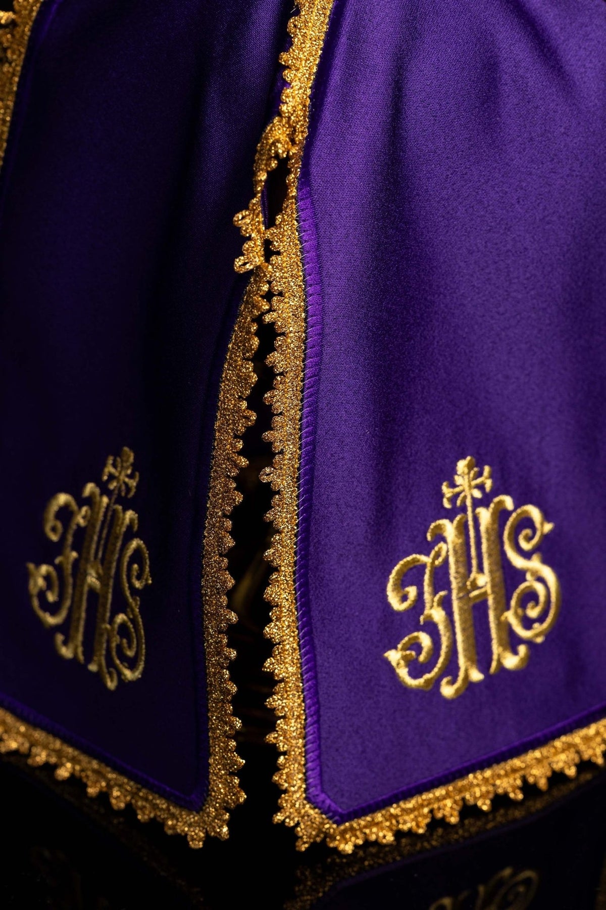 Purple ciborium veil detail showing gold embroidered IHS monograms and scalloped trim