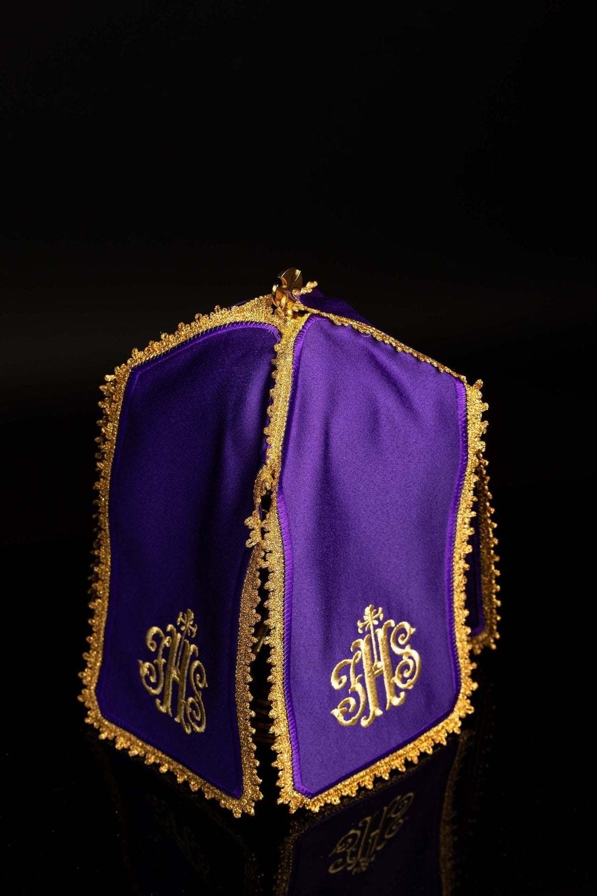 Purple ciborium veil angled view with gold IHS embroidery and decorative edging