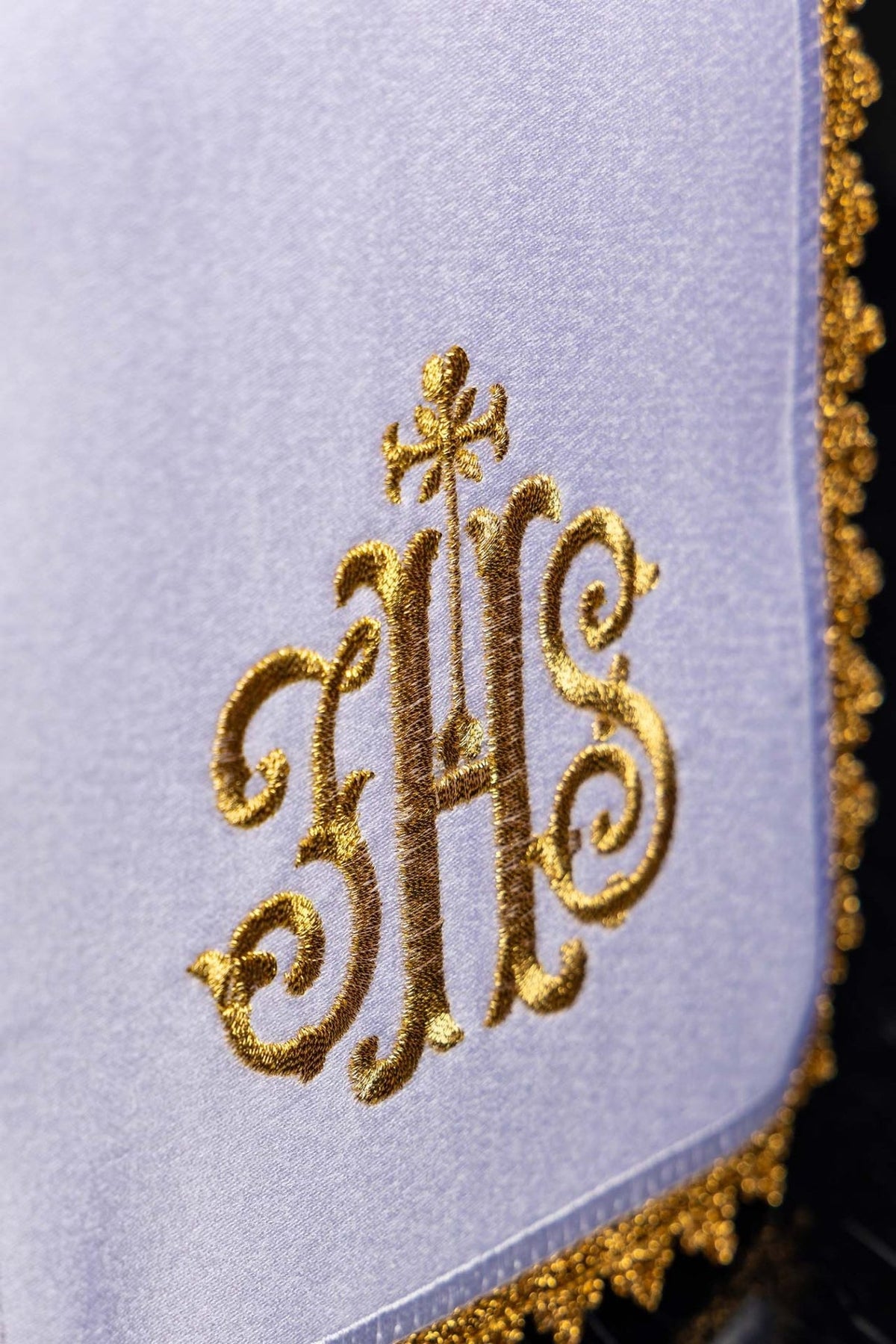 Ciborium veil close-up showing gold IHS embroidery on white fabric