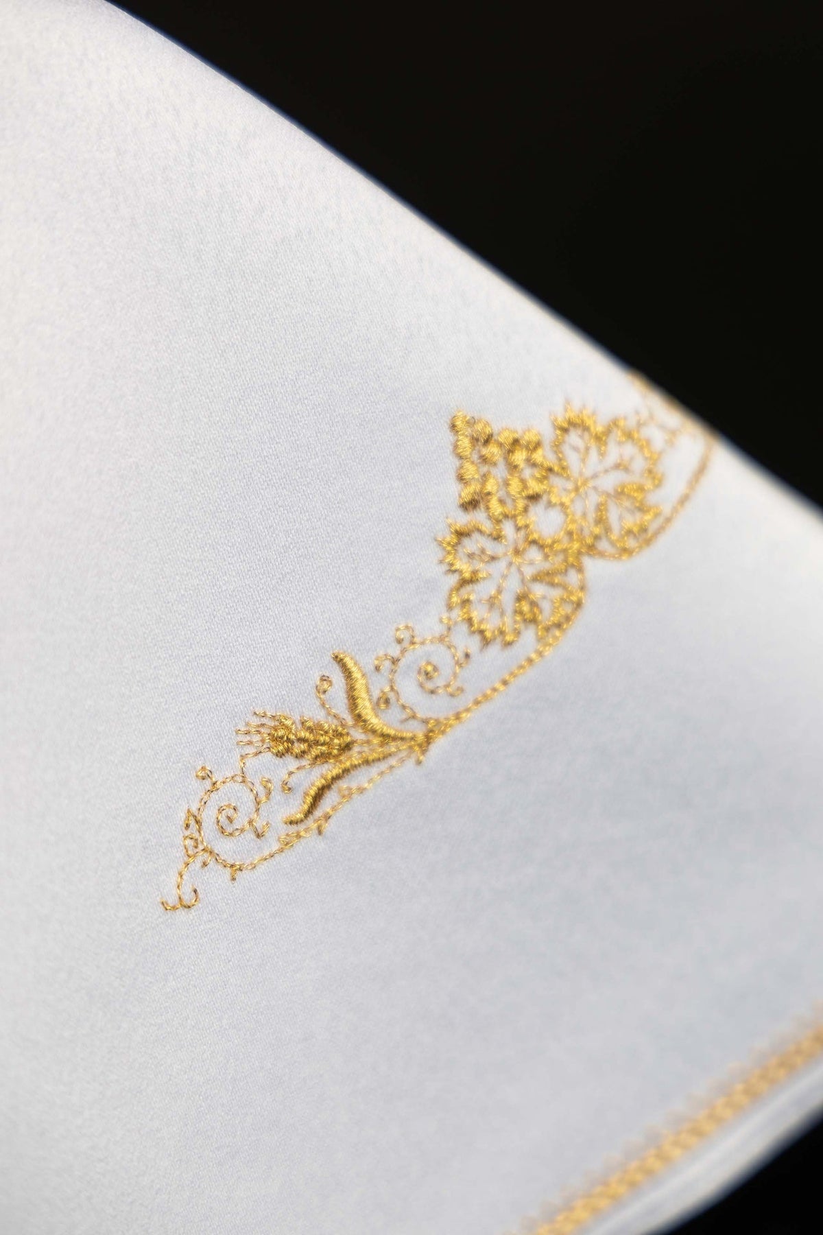Ciborium veil close-up of gold floral embroidery on white fabric