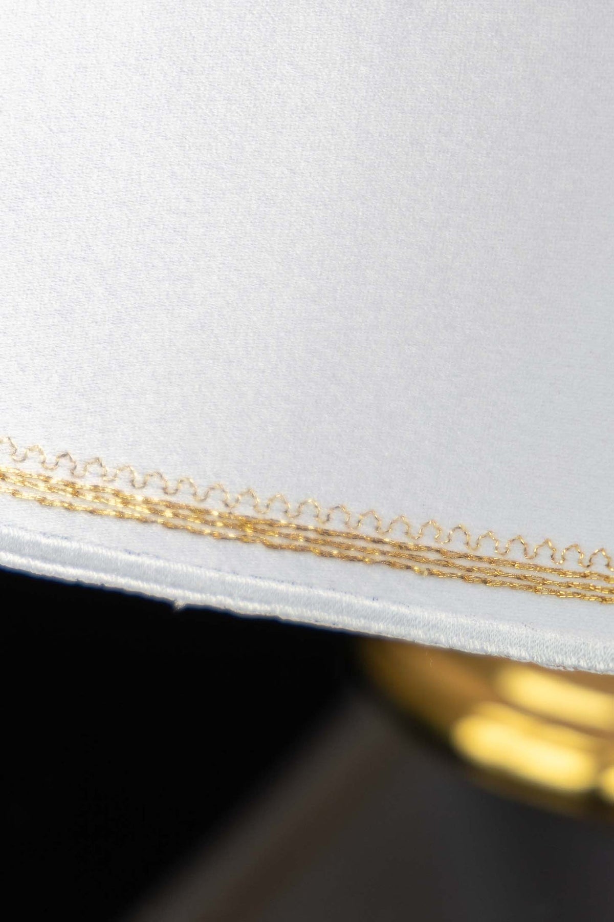 Ciborium veil close-up of gold embroidered edge on white fabric