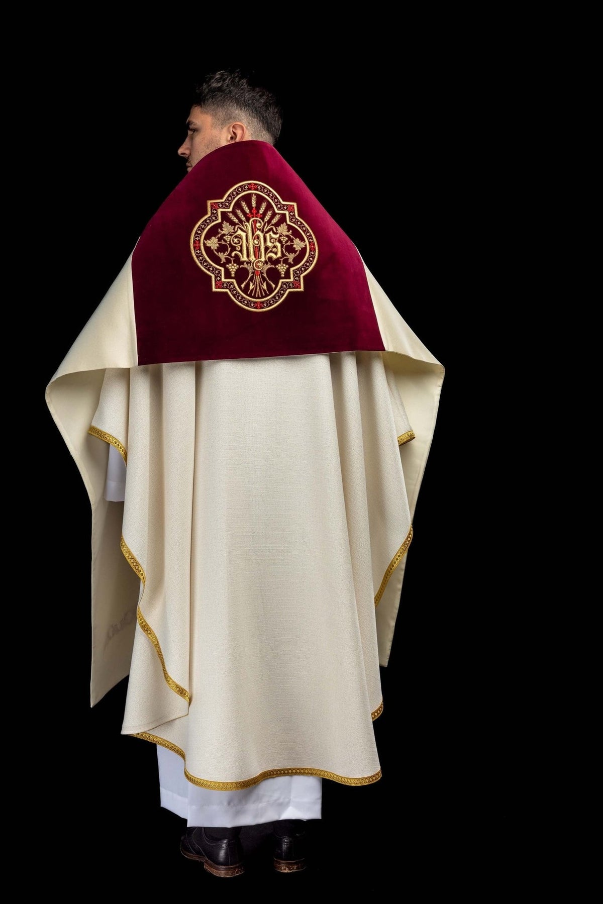 Humeral veil worn from the back, showing burgundy velvet, gold IHS embroidery and ecru lining