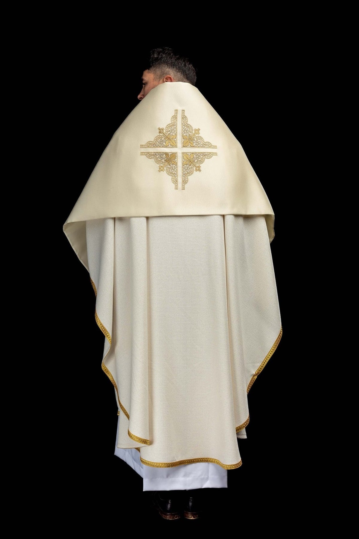 Humeral veil back view showing ecru fabric, gold edging and embroidered cross