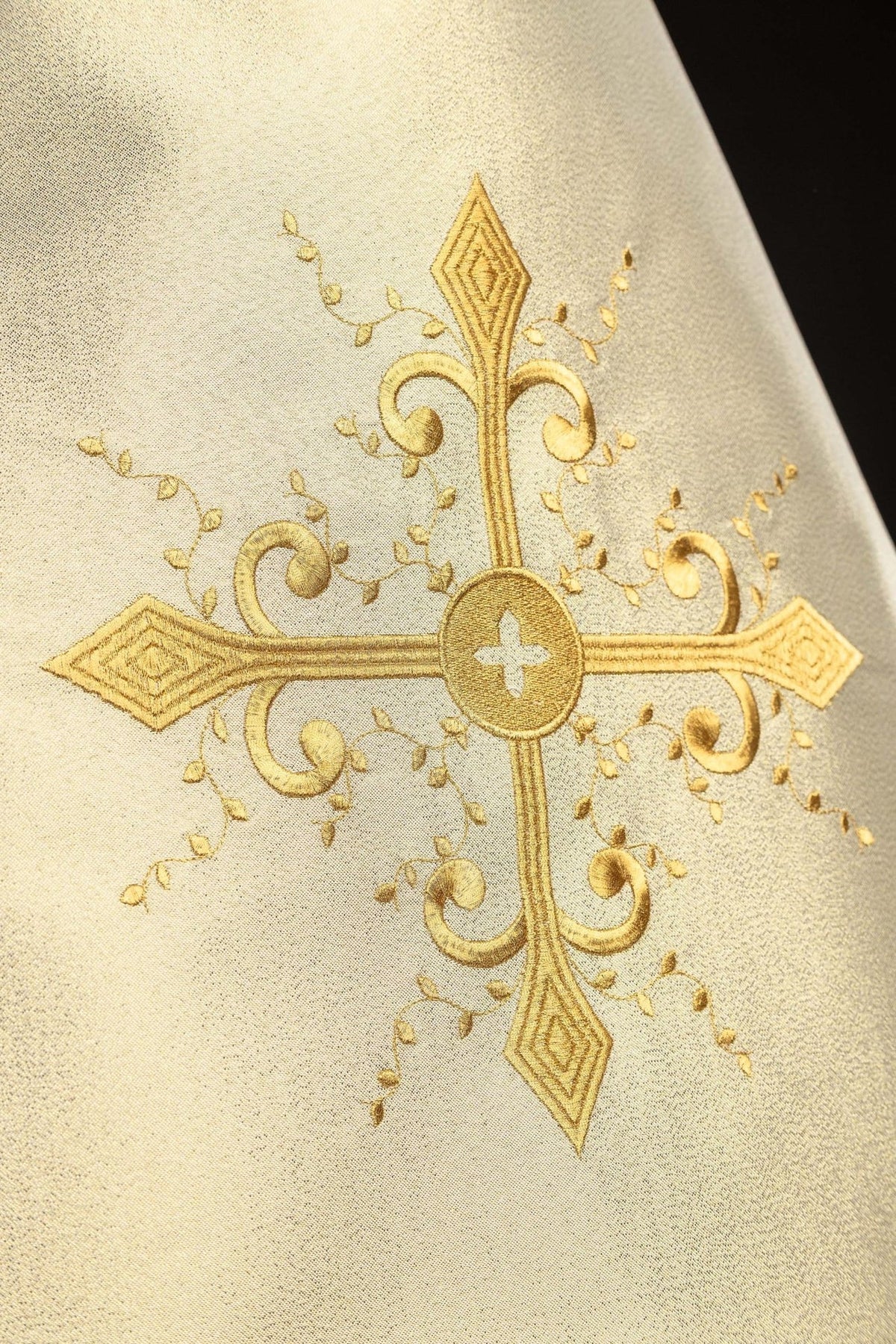 Humeral veil close-up showing embroidered gold cross and leafy details