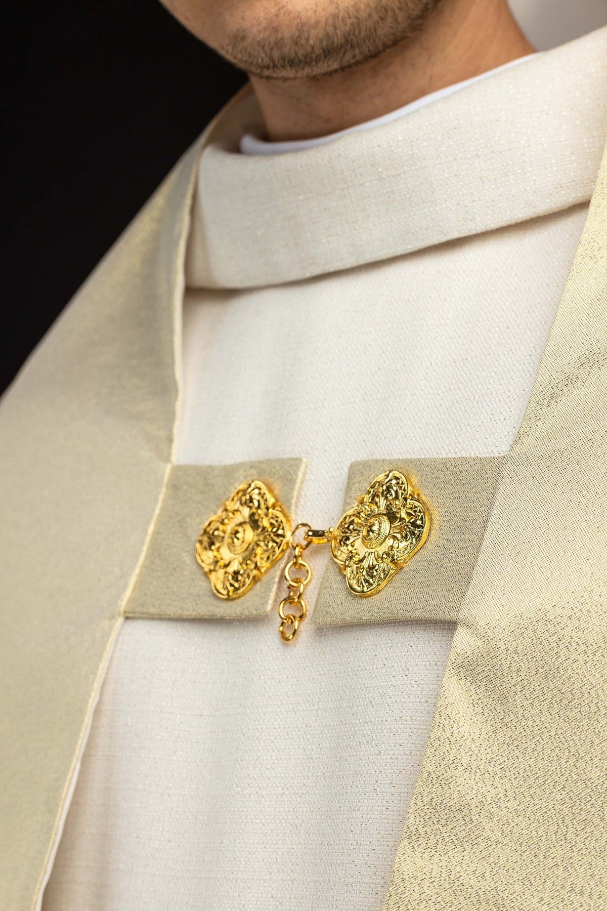 Gold humeral veil close-up showing ornate gold clasp