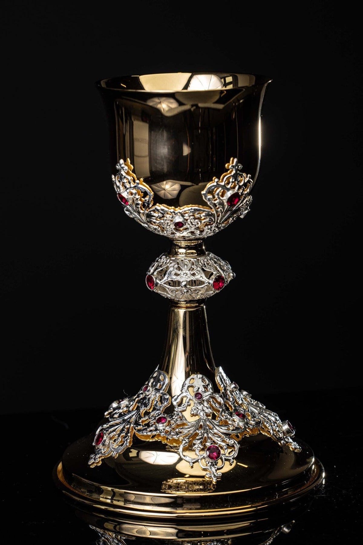 Gold-plated chalice front view showing ornate cup, stem and ruby-studded base