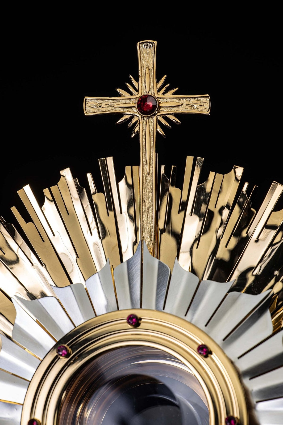 Gold-plated brass monstrance close-up of the cross with a central ruby decoration