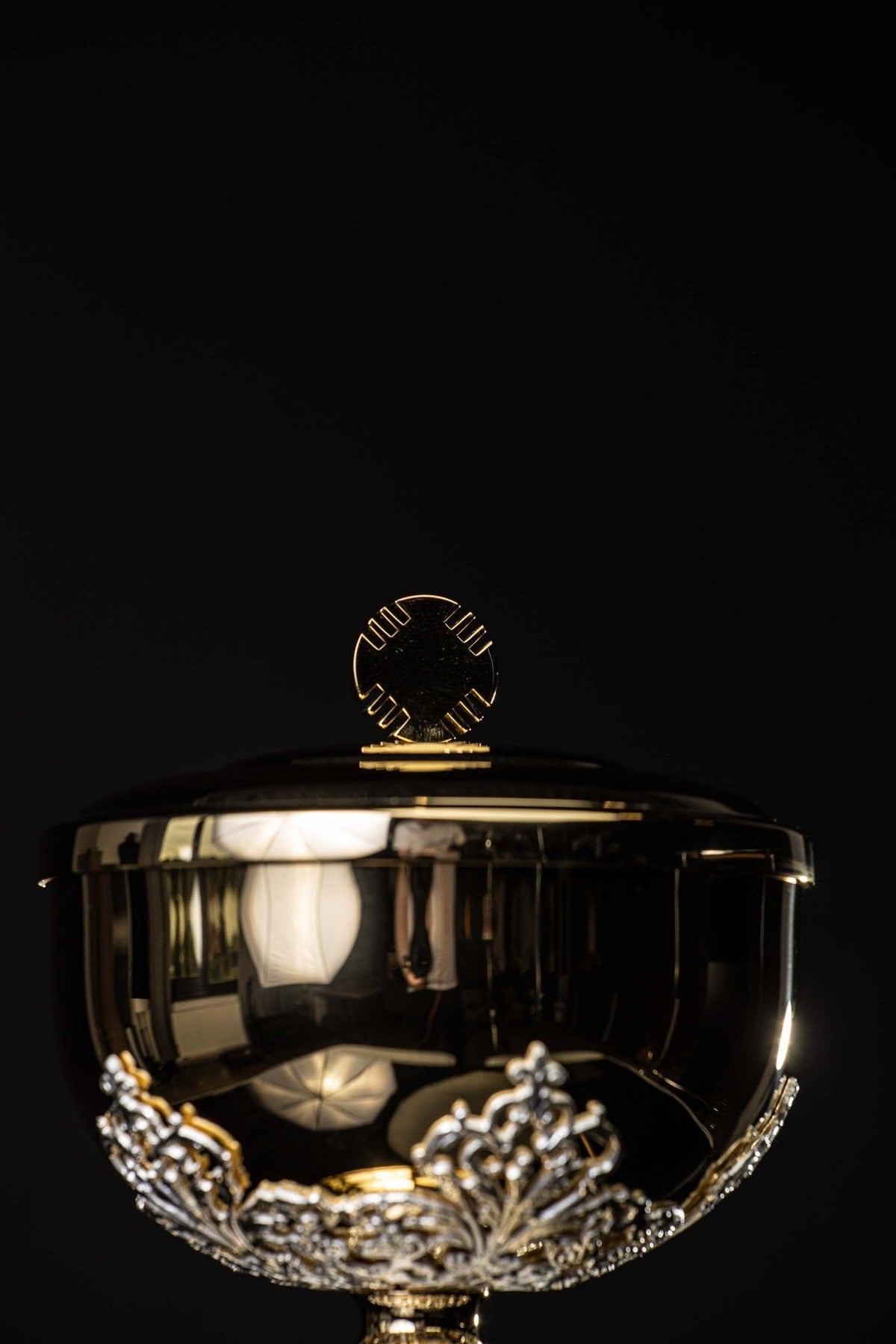 Ciborium detail showing silver openwork node and decorated bowl rim