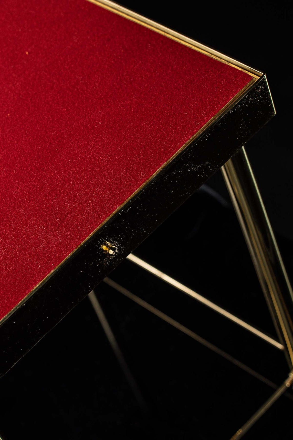 Thabor table side detail showing ornate scrollwork, column and fastening hardware
