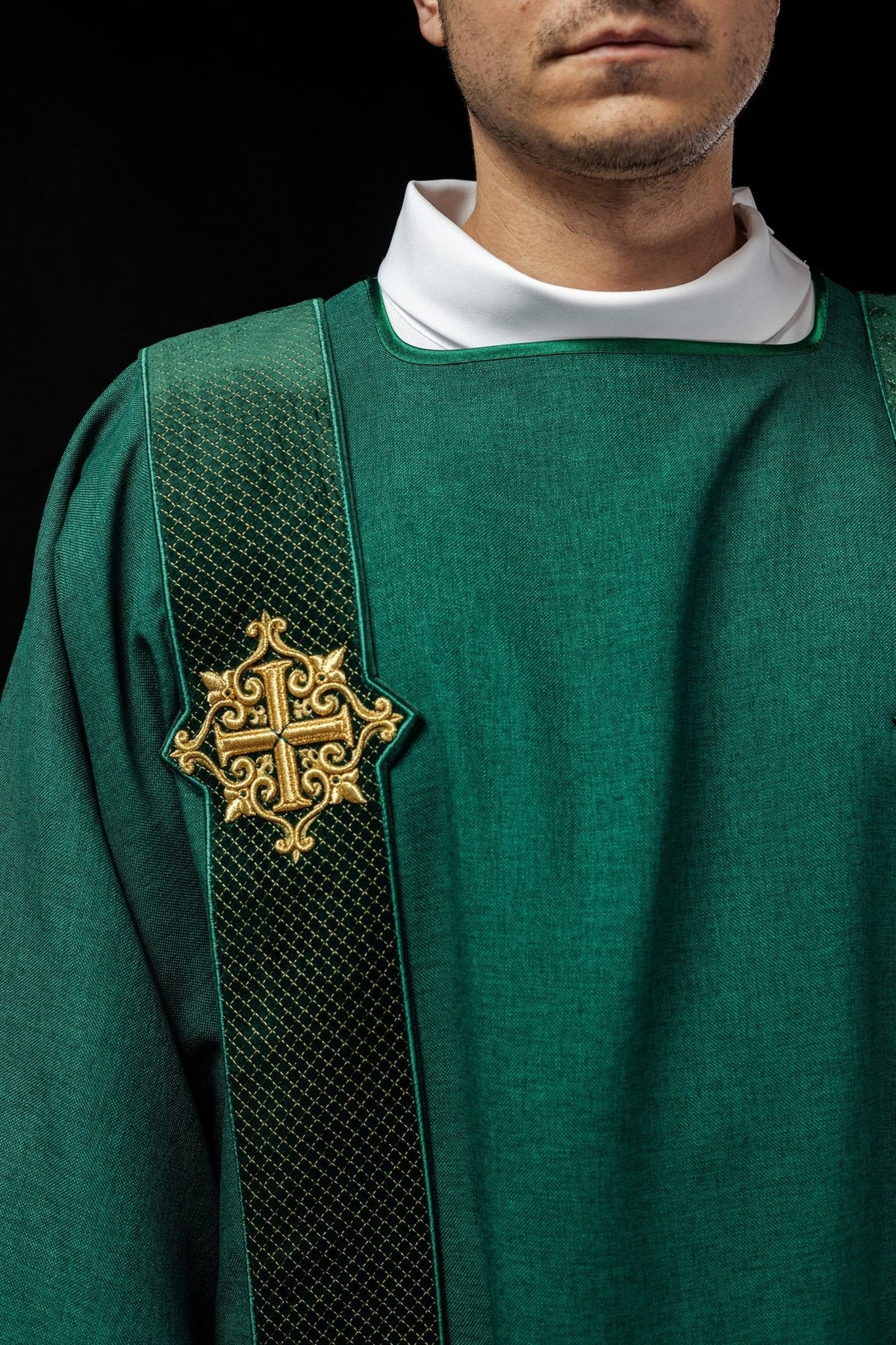 Green velvet dalmatic, close-up of embroidered gold cross and diamond-patterned orphrey