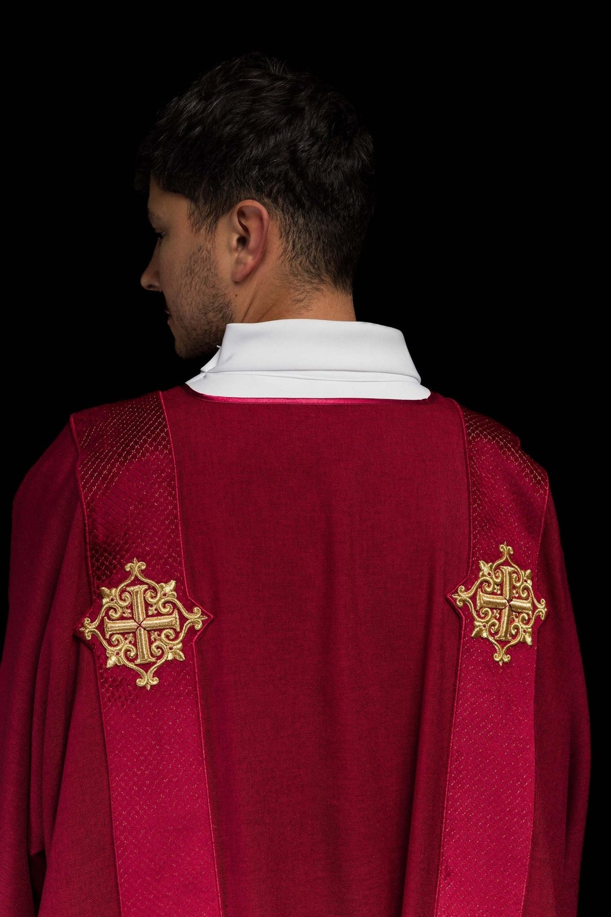 Dalmatic close-up of red velvet orphrey with gold embroidered cross