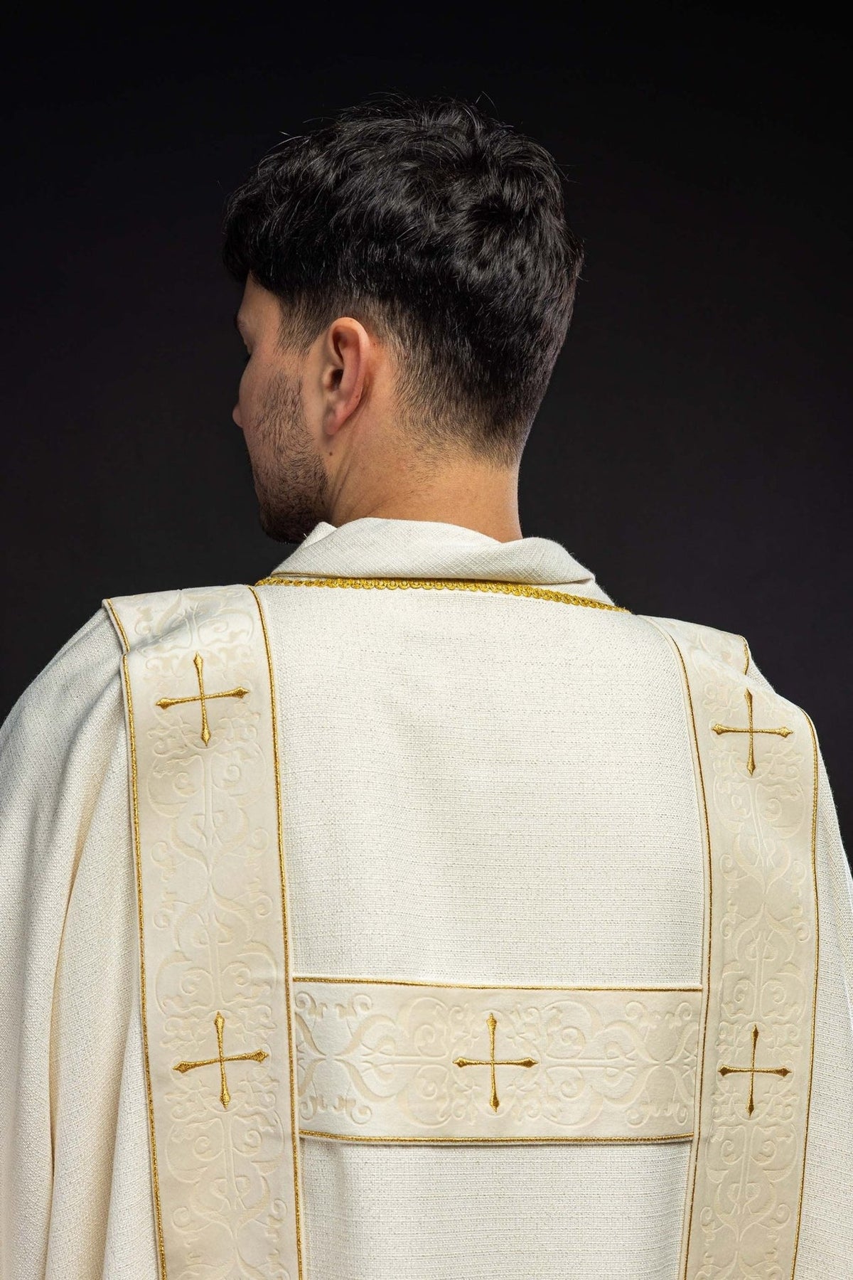 Ecru dalmatic back view with velvet orphreys and embroidered gold crosses