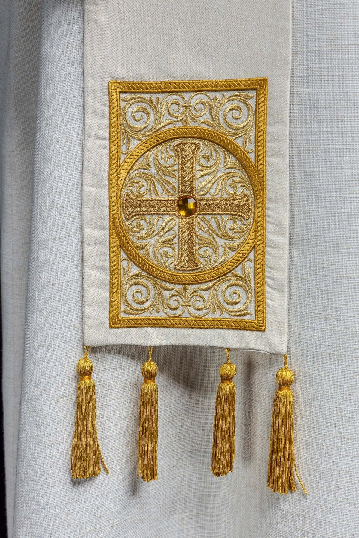 Priest stole close-up showing gold embroidered cross and four gold tassels
