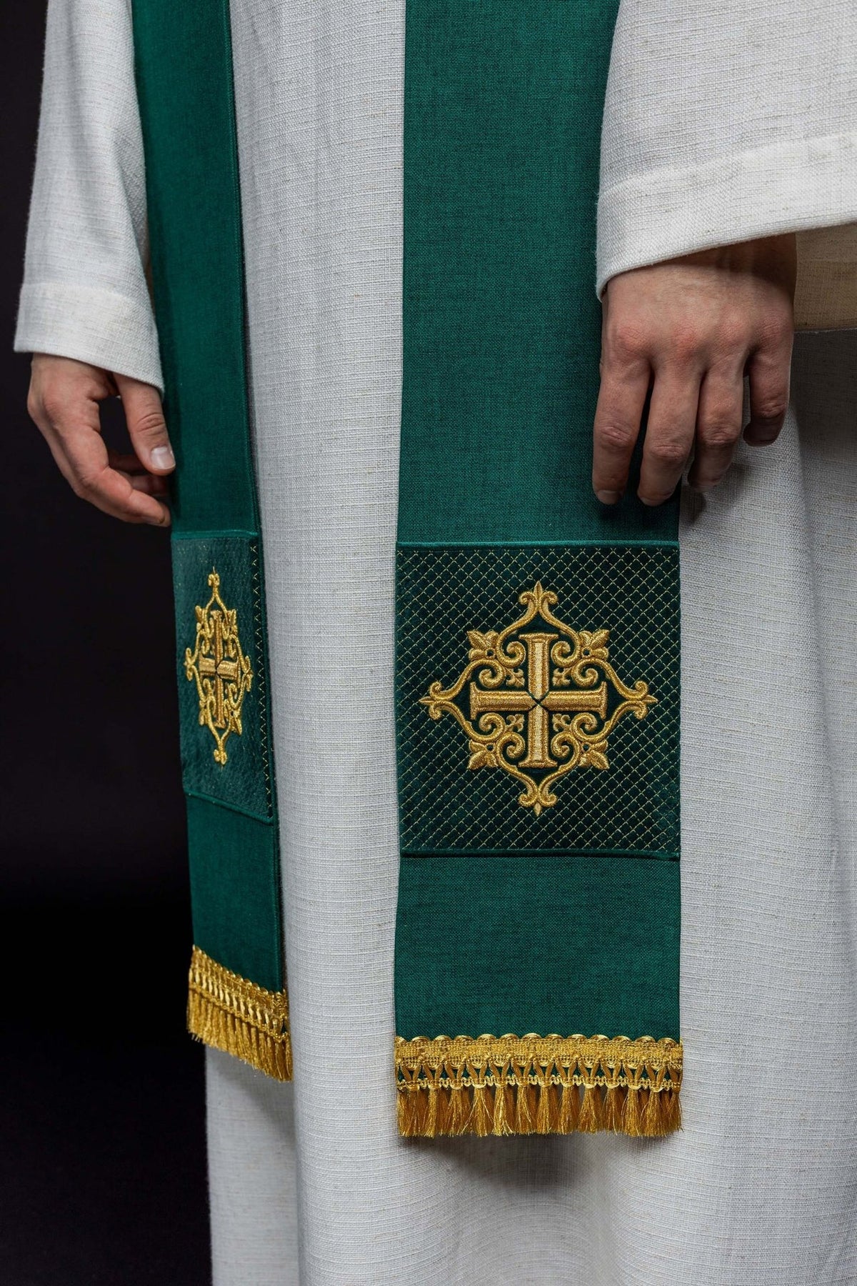 Green velvet stole worn front view with embroidered cross panels and gold fringe
