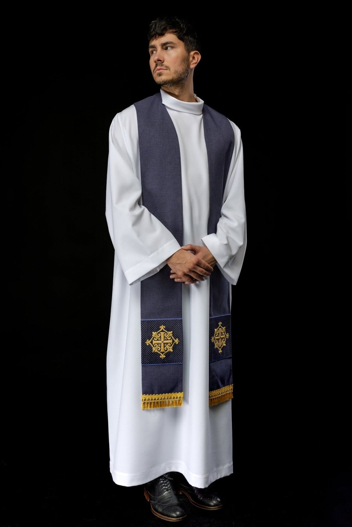 Purple velvet stole worn front view showing gold cross embroidery and fringe