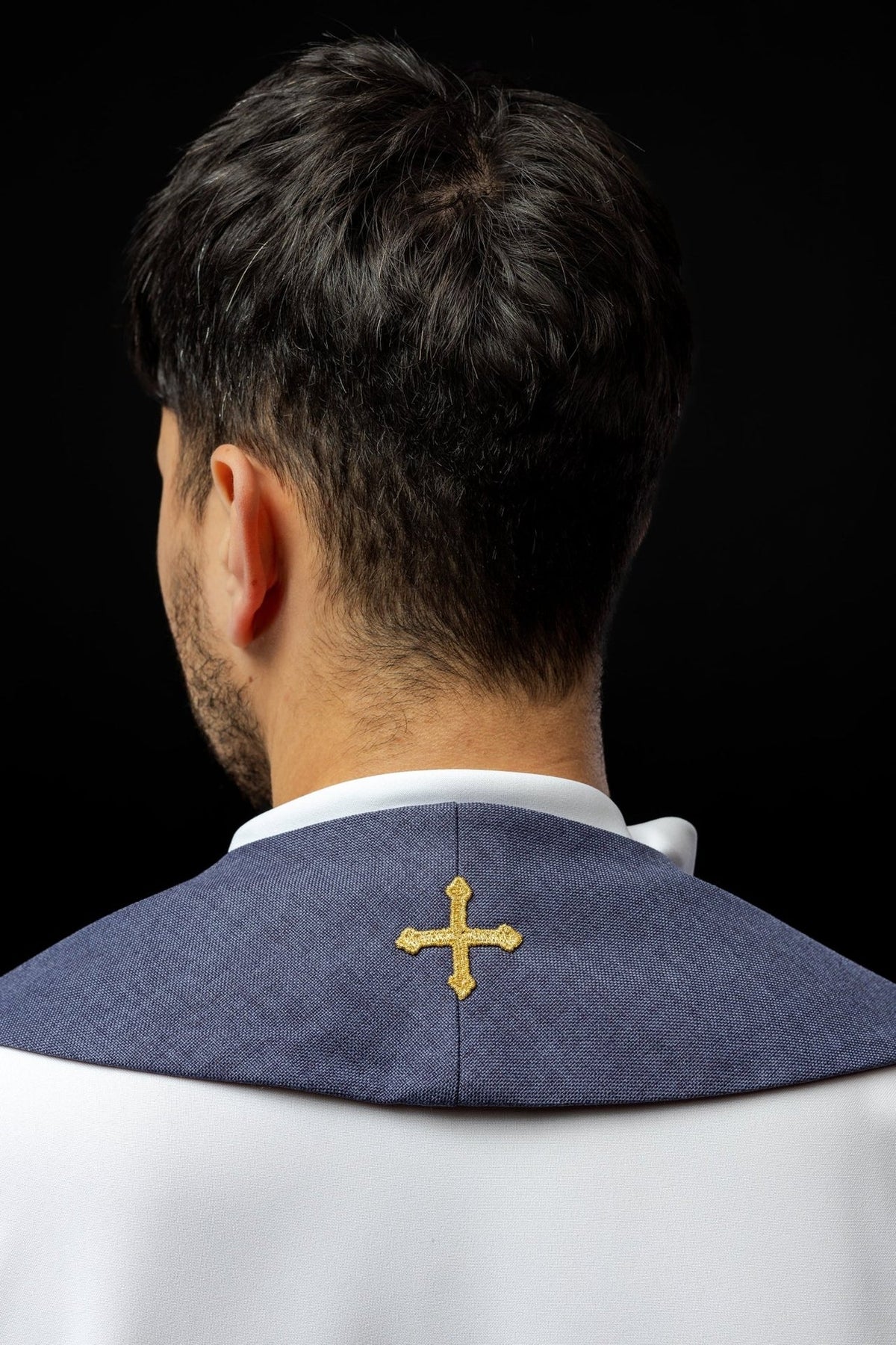 Purple velvet stole back view showing a small embroidered cross