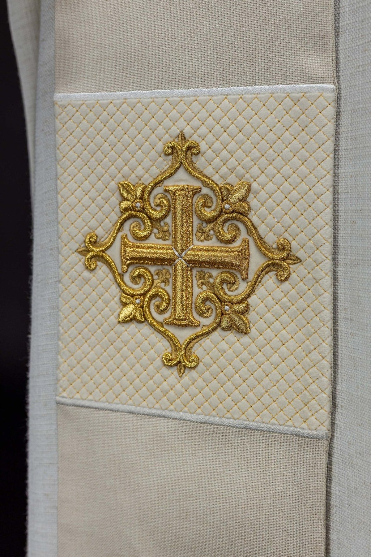 Ecru velvet stole close-up showing ornate embroidered cross symbol
