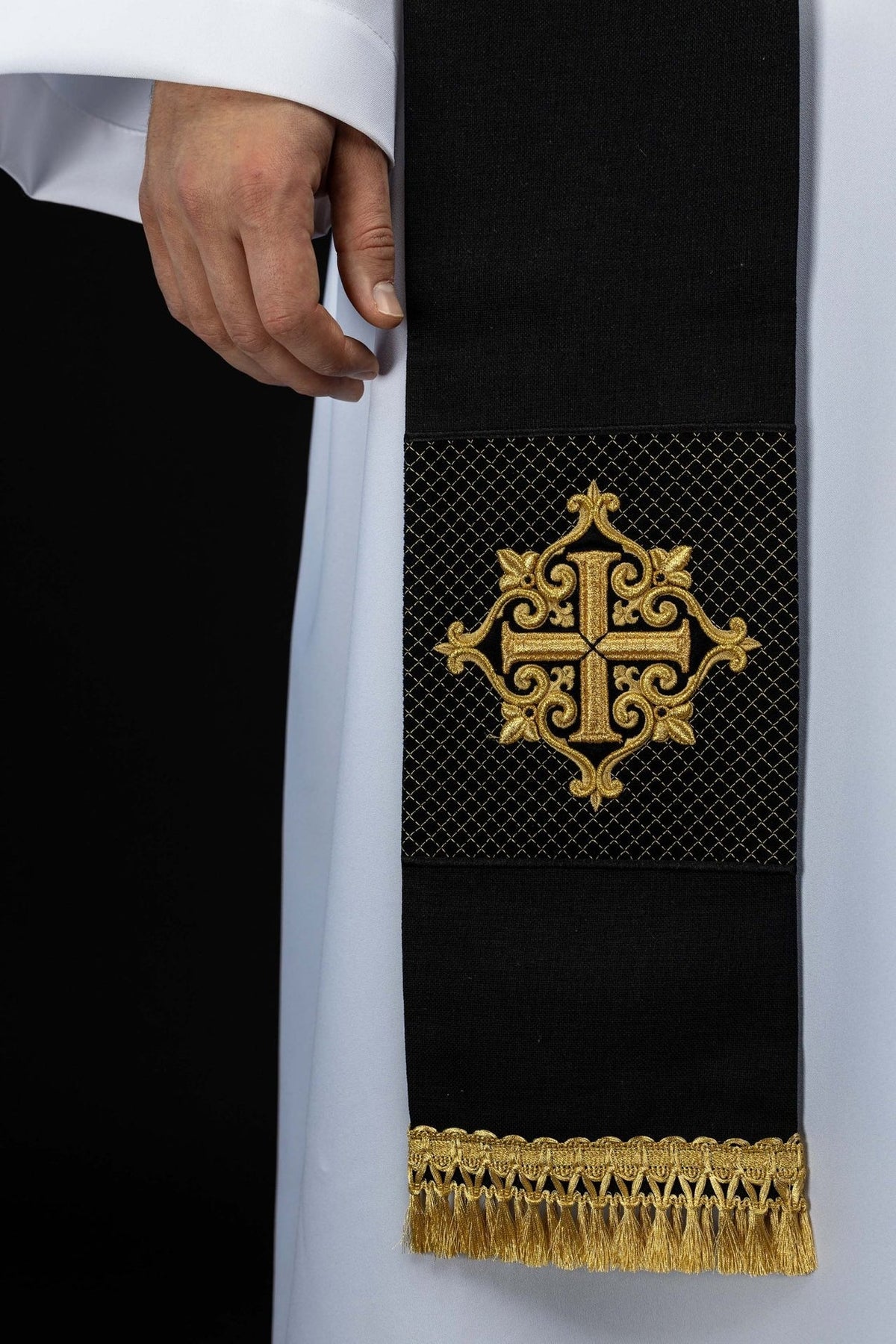 Black stole close-up showing gold cross embroidery and fringe