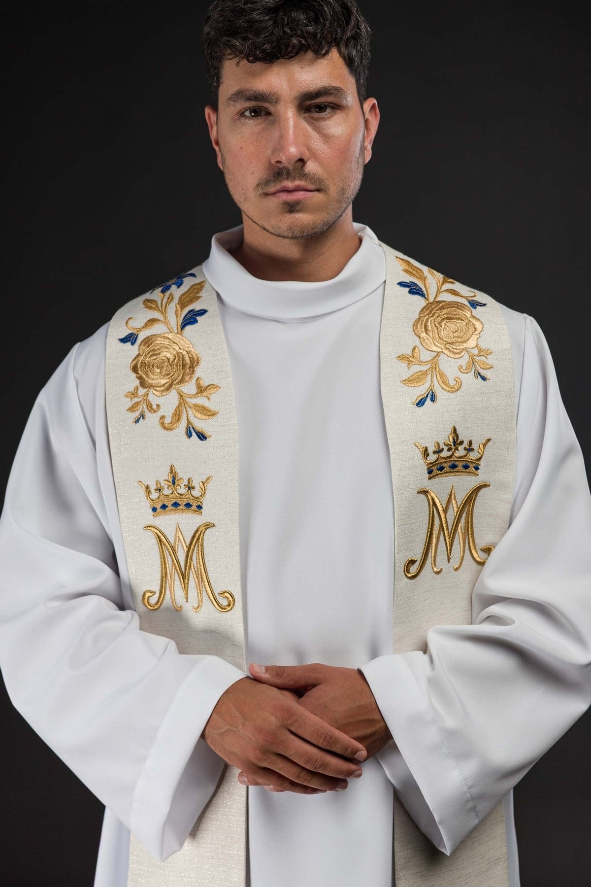 Embroidered stole close-up with gold roses, blue accents and crowned Marian symbols