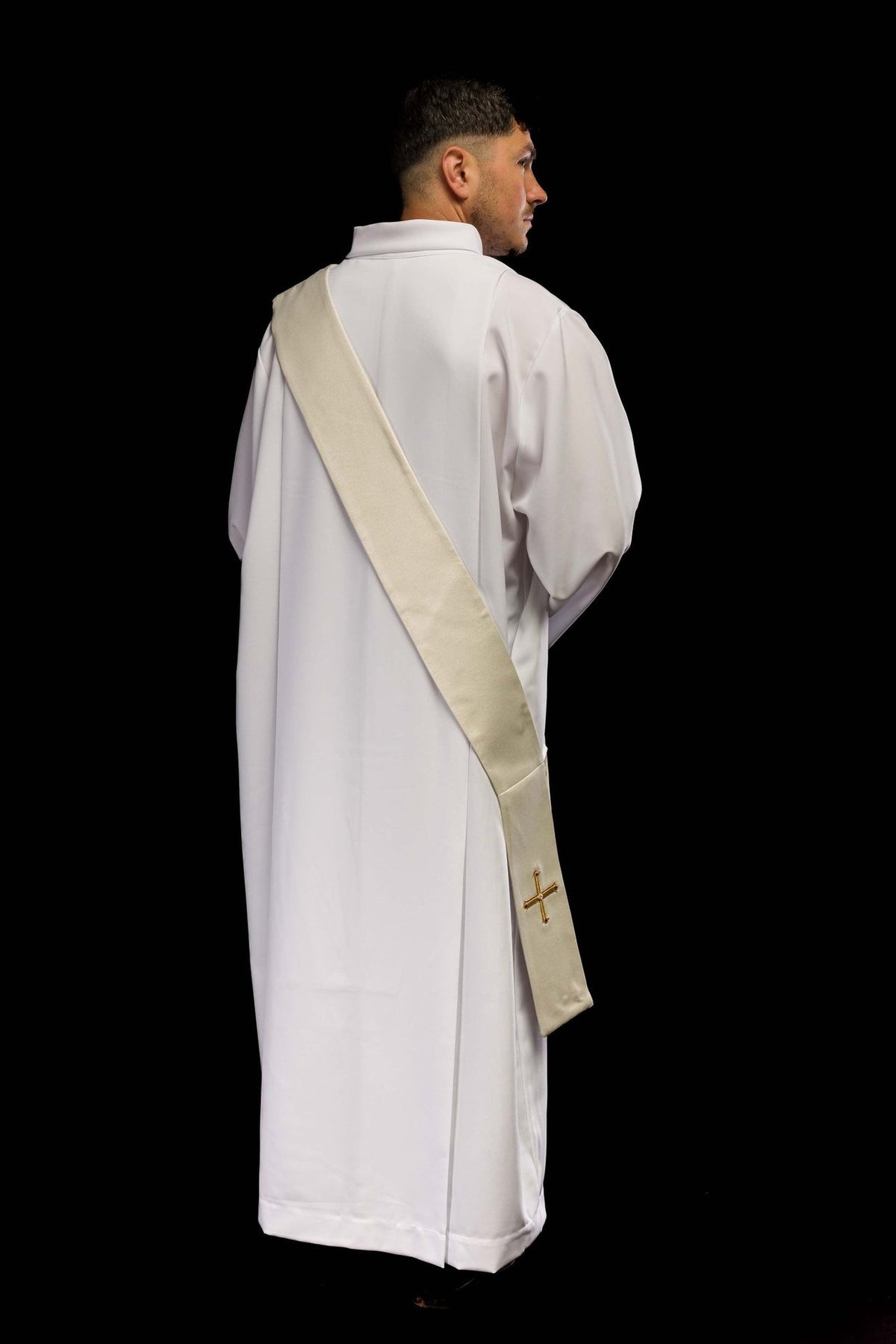 Deacon stole worn back view in ivory with a plain reverse and gold cross at the end