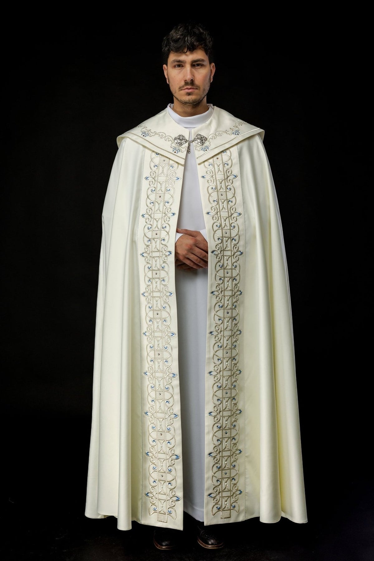Ivory cope front view with long embroidered panels and blue and gold motifs