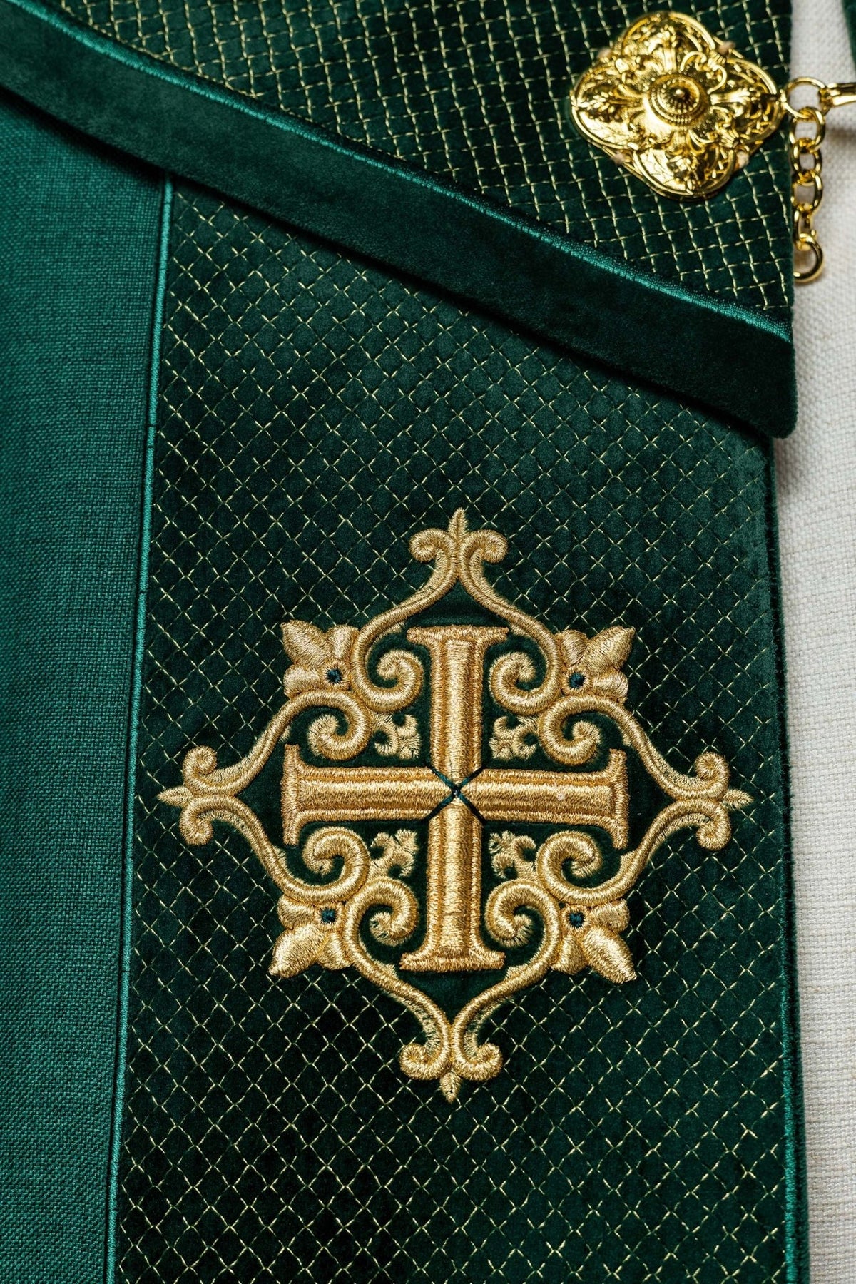 Green velvet cope, close-up of embroidered gold cross and diamond embroidery