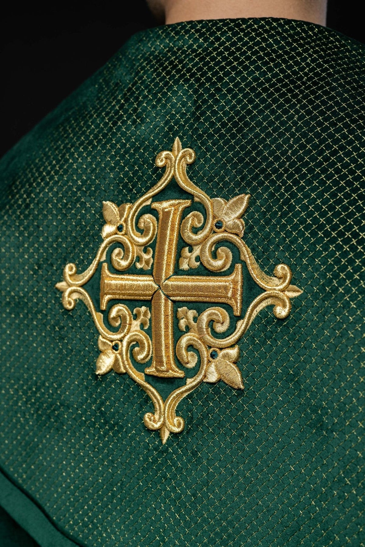 Green velvet cope, close-up of gold cross embroidery on diamond-patterned orphrey