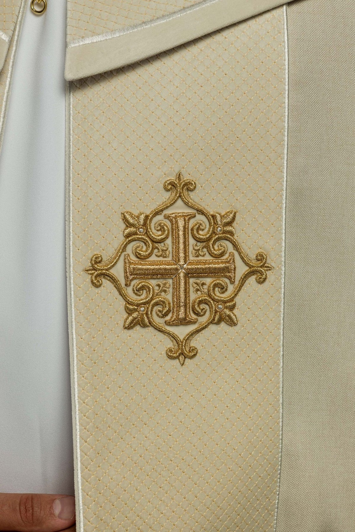Cope orphrey close-up with ornate gold cross embroidery on ecru velvet