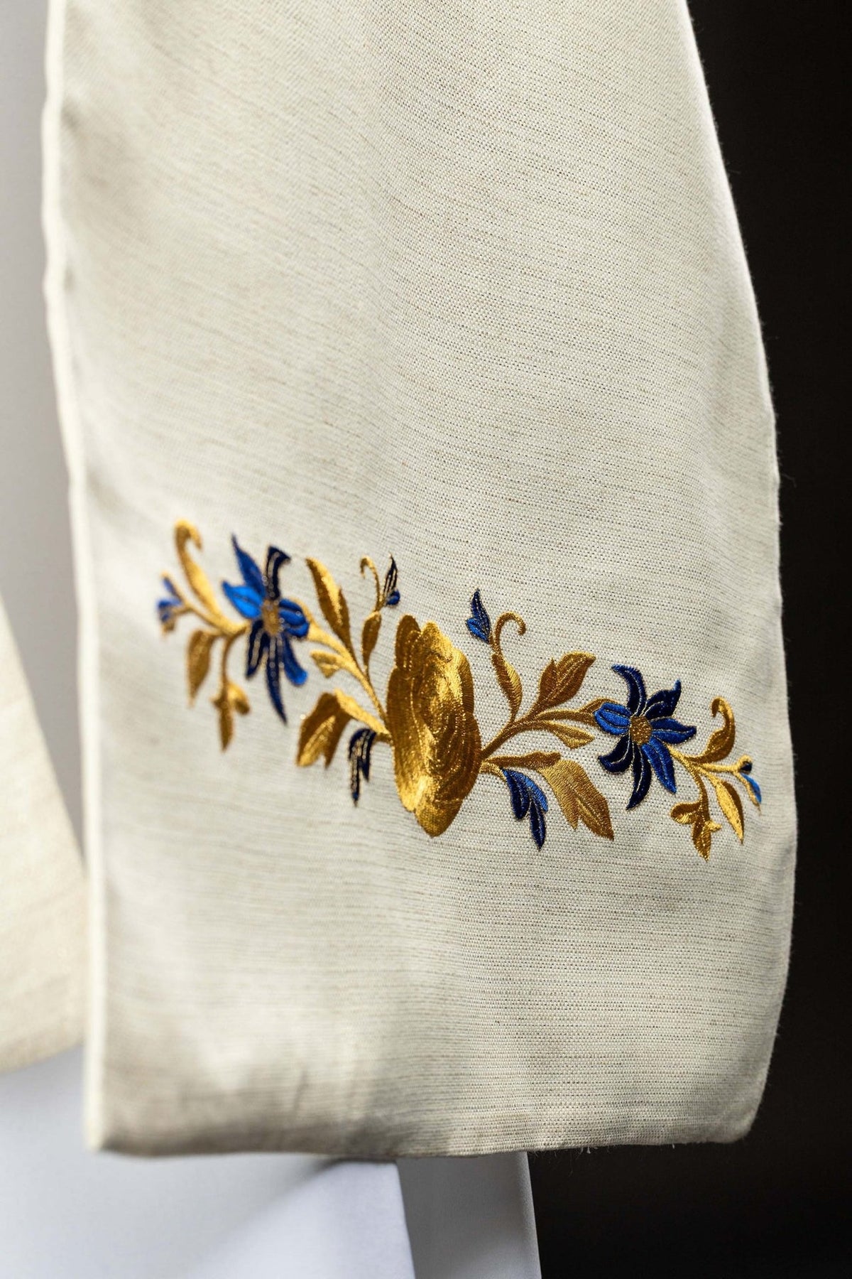 Humeral veil side detail with blue and gold floral embroidery near the edge