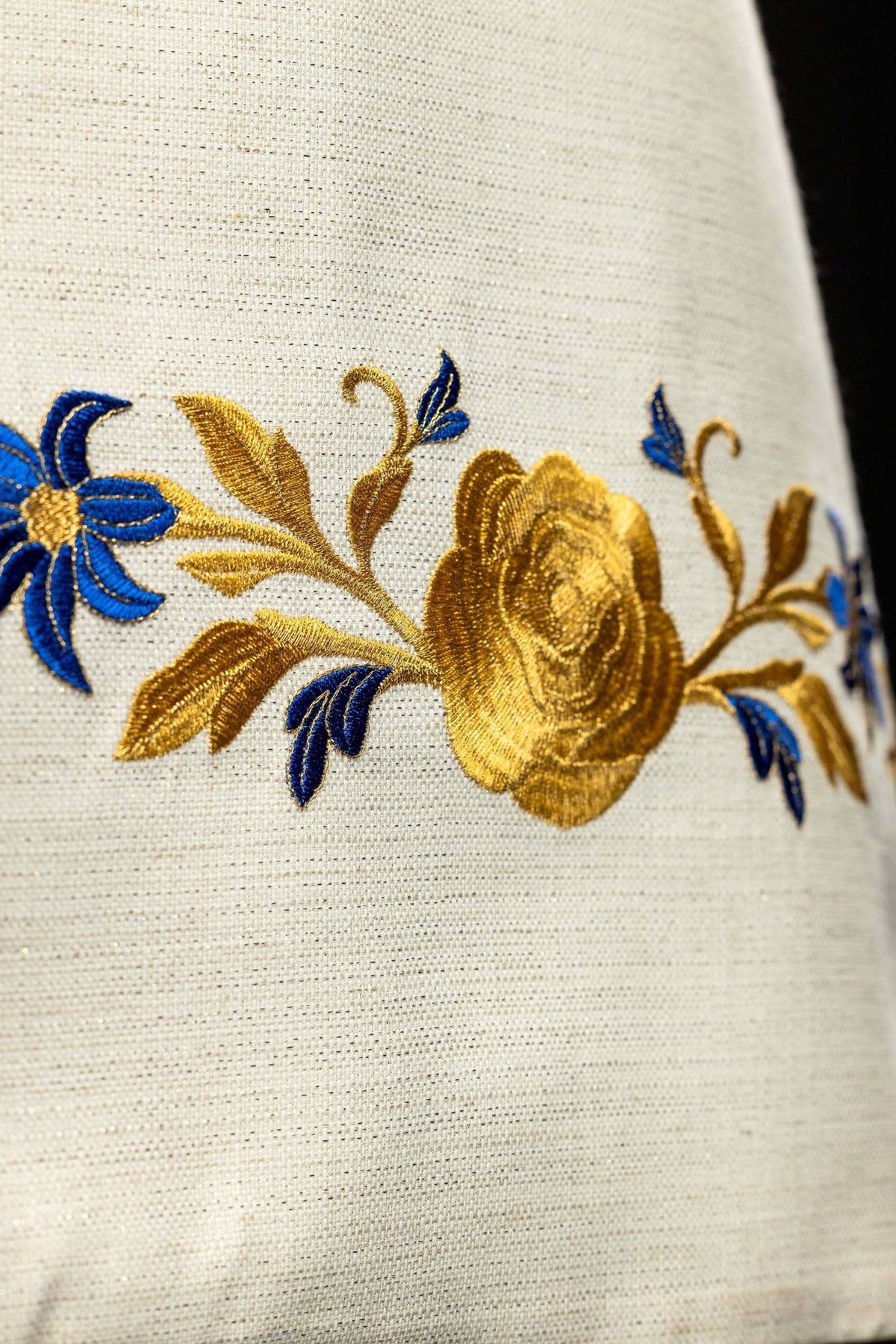 Humeral veil close-up of gold rose and blue floral embroidery