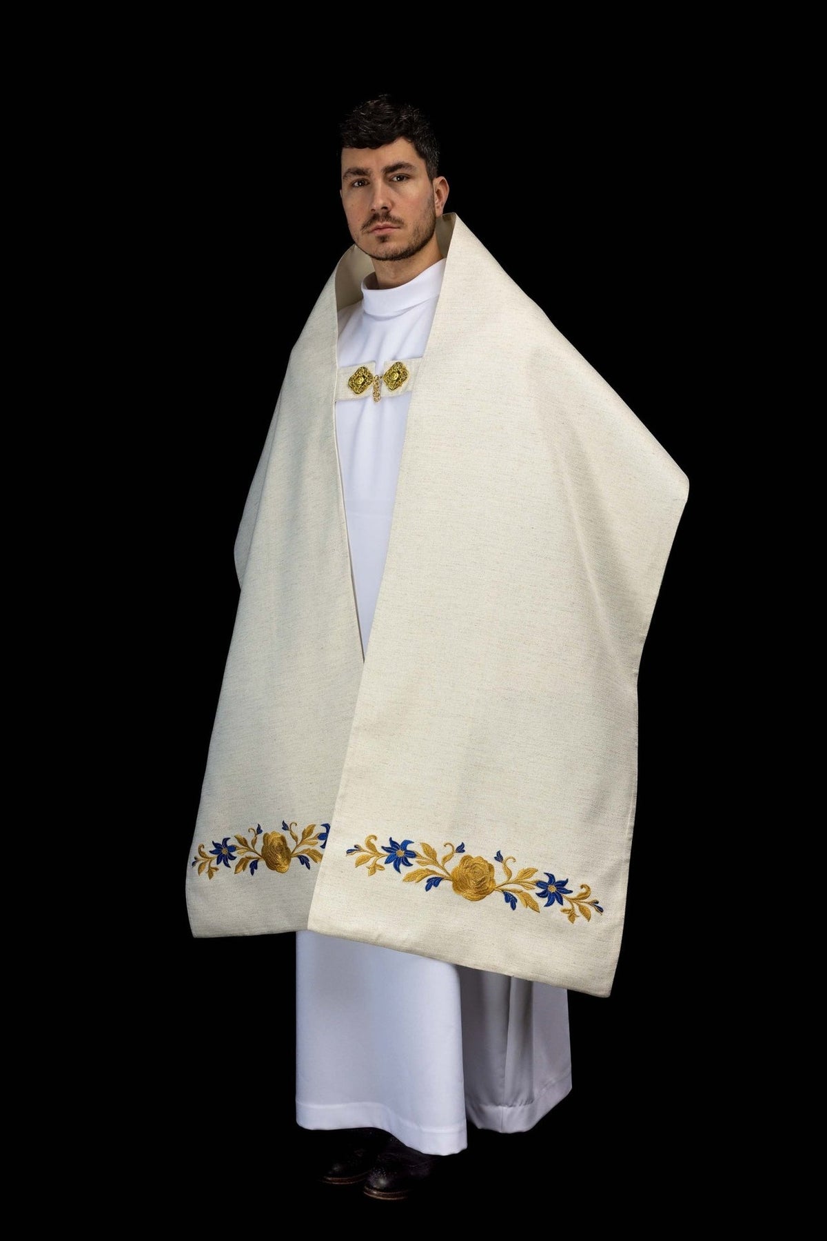 Ecru humeral veil worn side view with floral embroidery along the lower edge