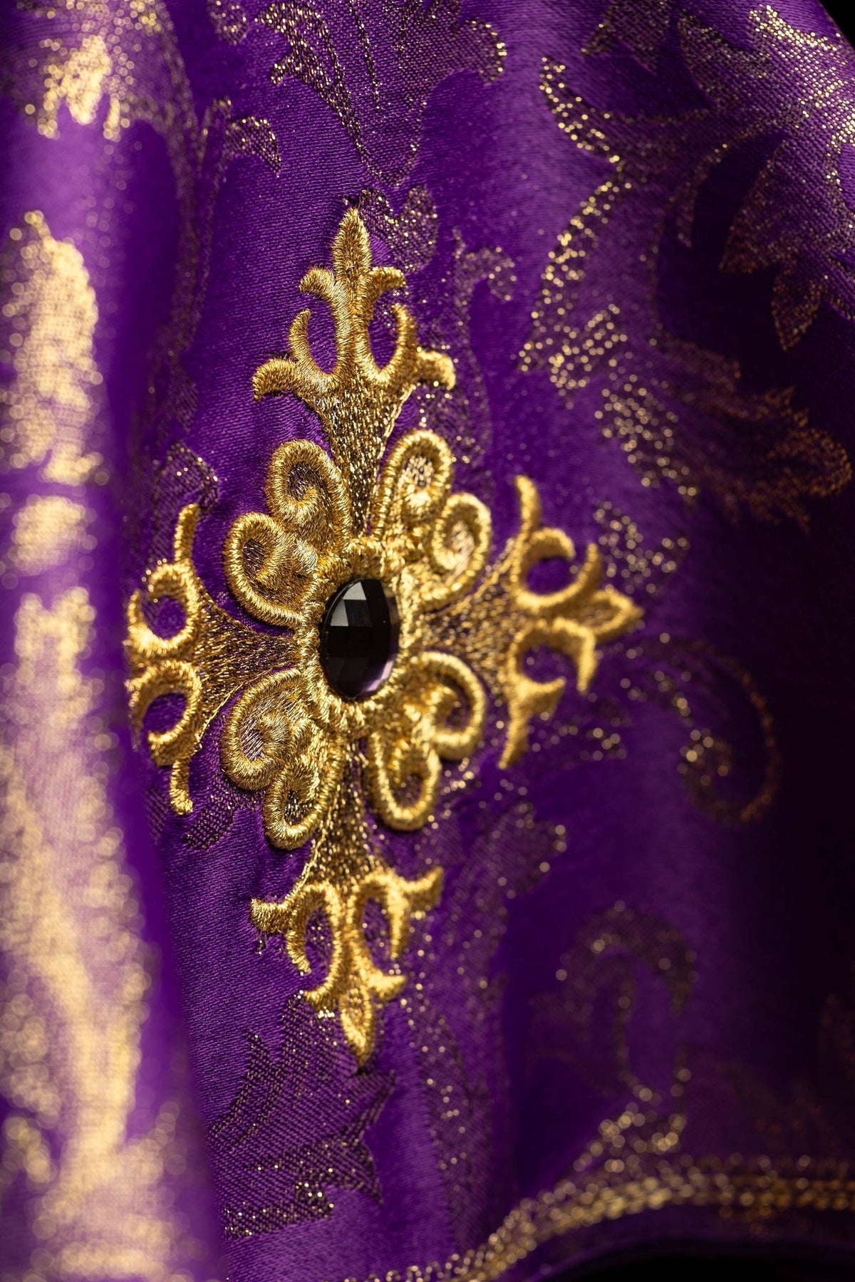Ciborium veil close-up showing embroidered gold cross motif and black stone
