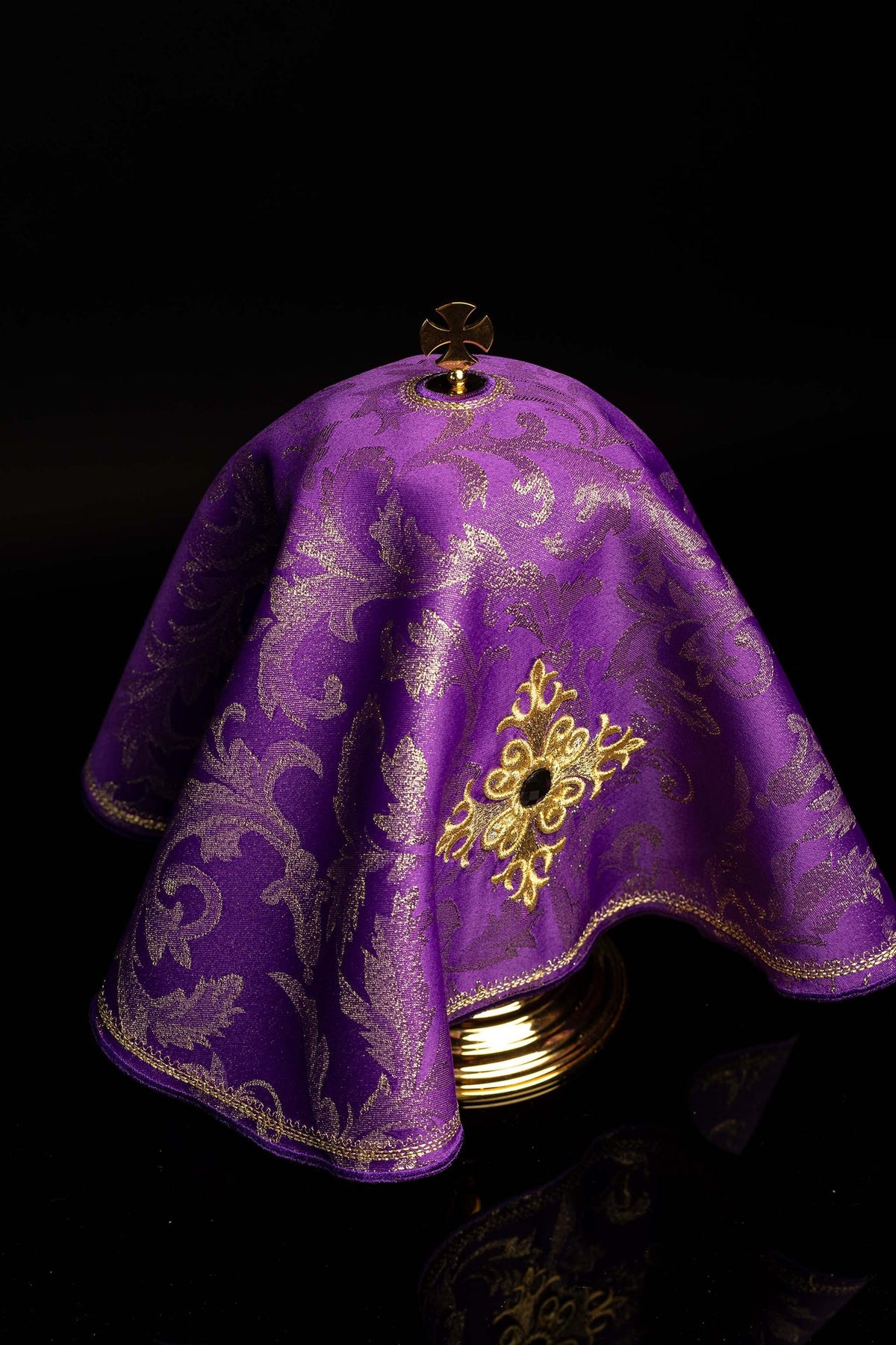 Purple ciborium veil angled view showing embroidered motif, cross finial, and gold trim