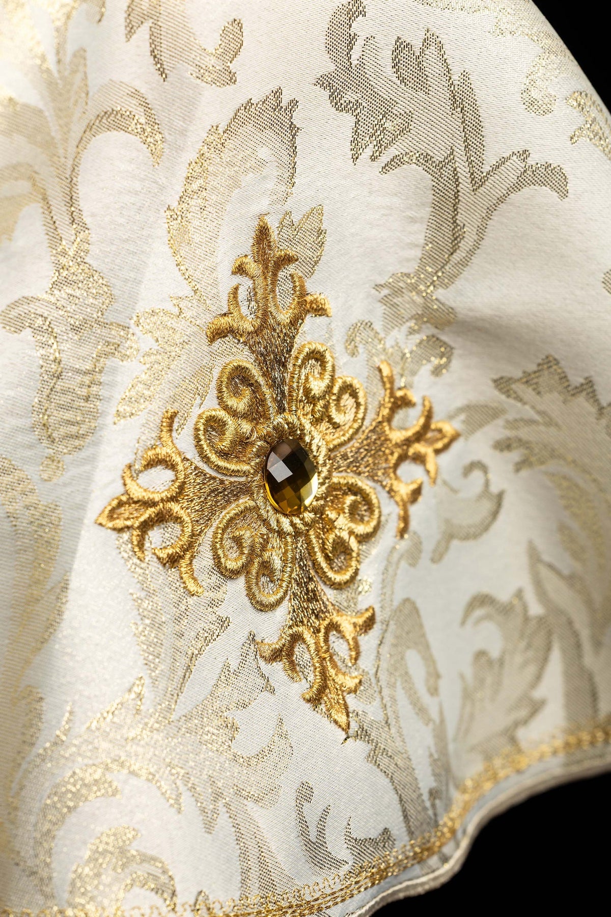 Ciborium veil close-up showing embroidered gold cross motif and central stone