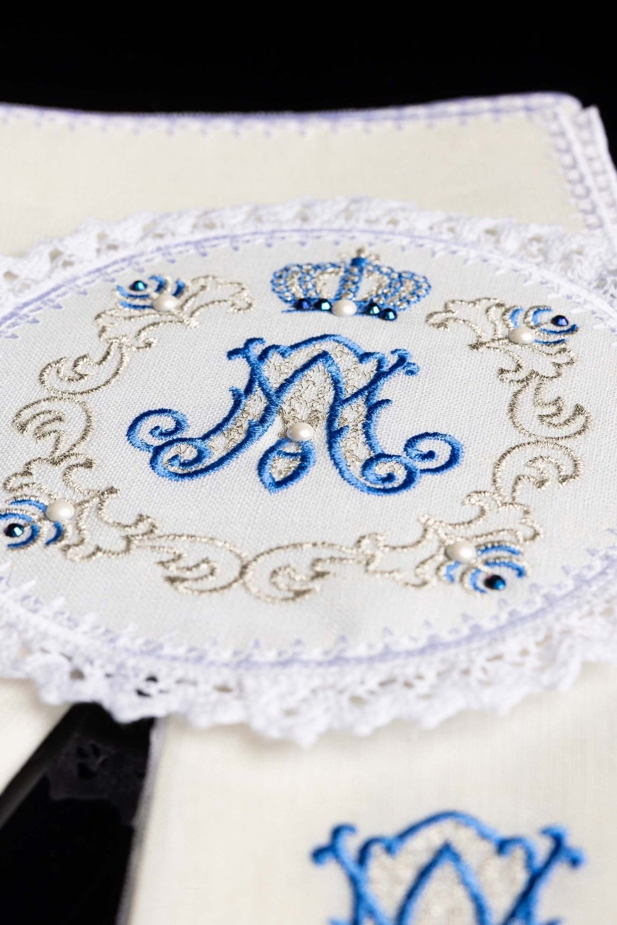 Altar linen set close-up showing blue Marian symbol, gold embroidery, beads and lace trim