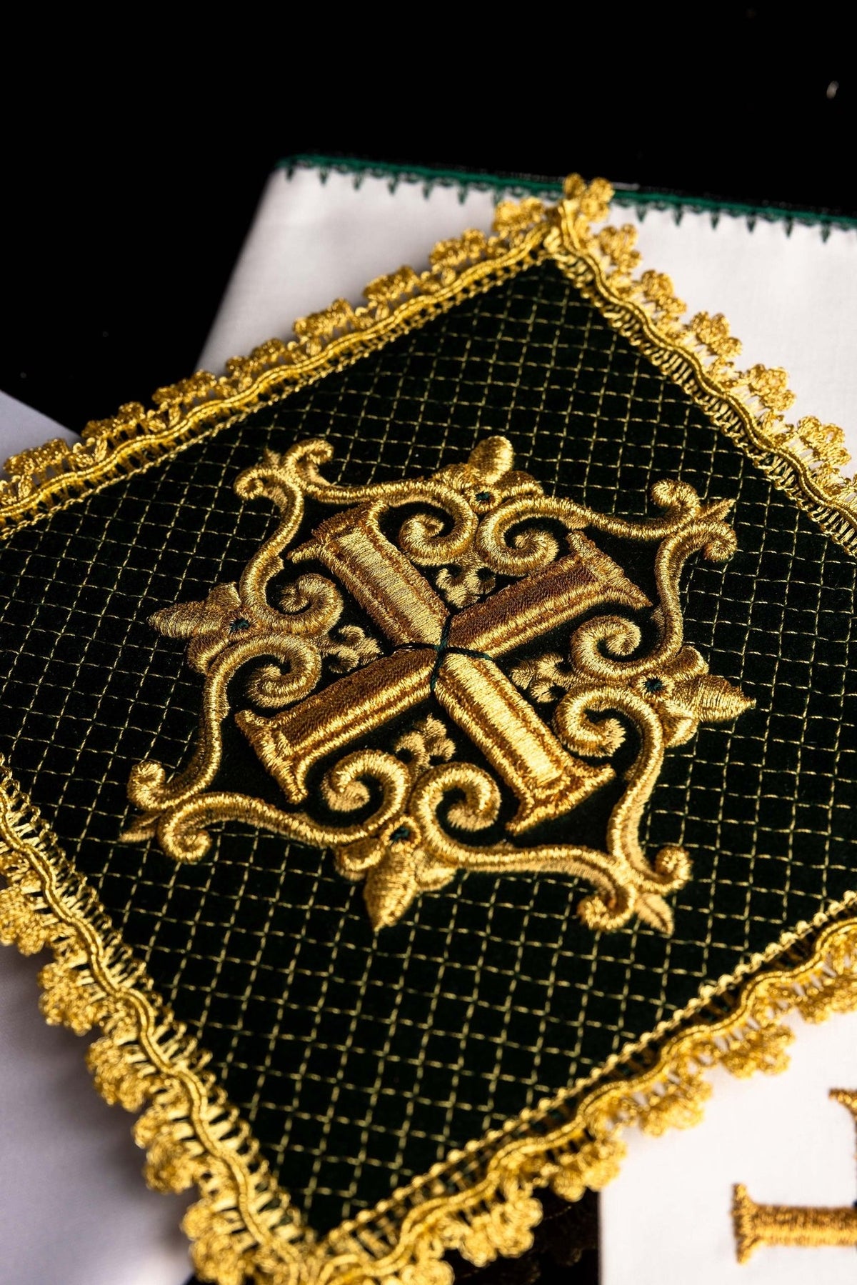 Altar linen set close-up of green velvet chalice pall with gold embroidered cross and ornate gold trim